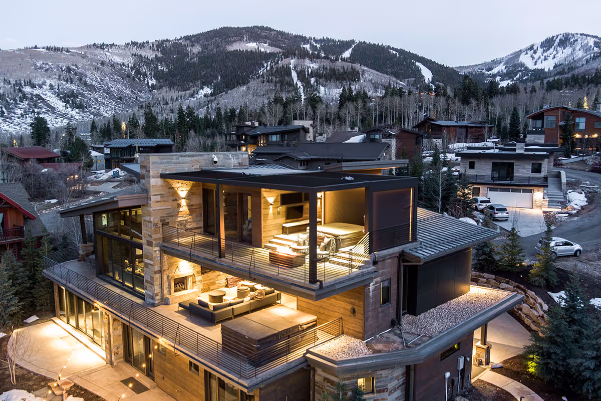 A motorized louvered roof atop a Salt Lake City home that has ambient lighting.