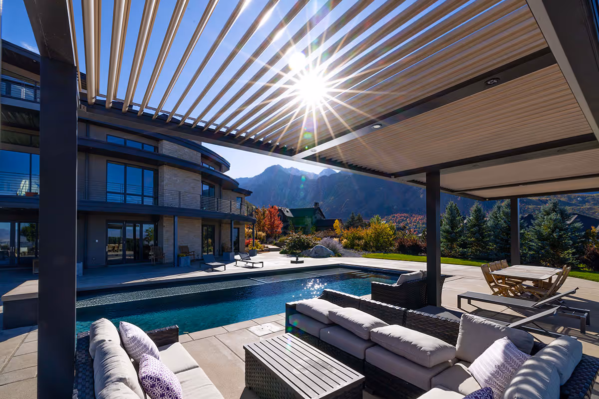 A motorized louvered roof in Salt Lake City during the autumn with the sun piercing through.