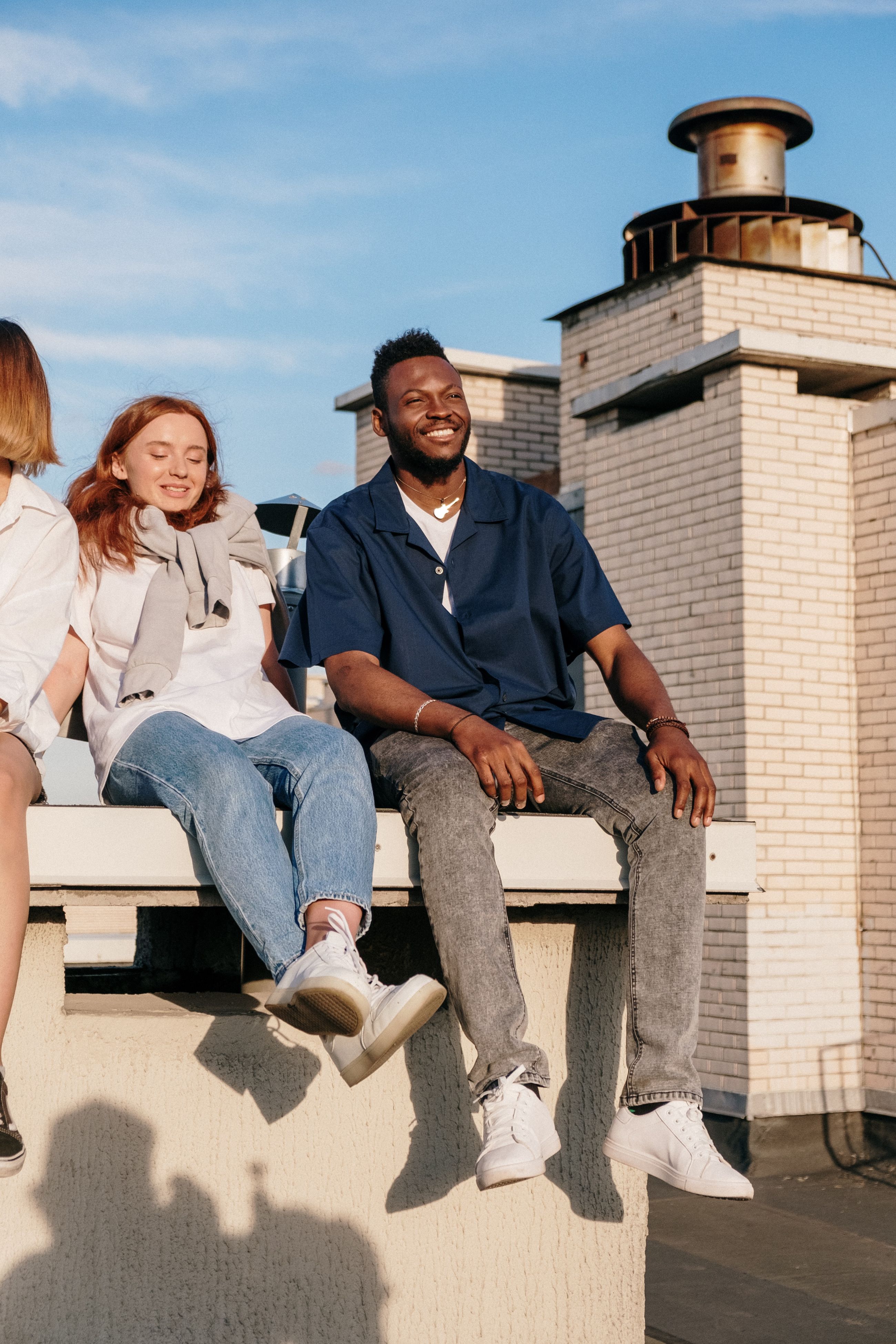 man and woman sitting in sunlight stock image