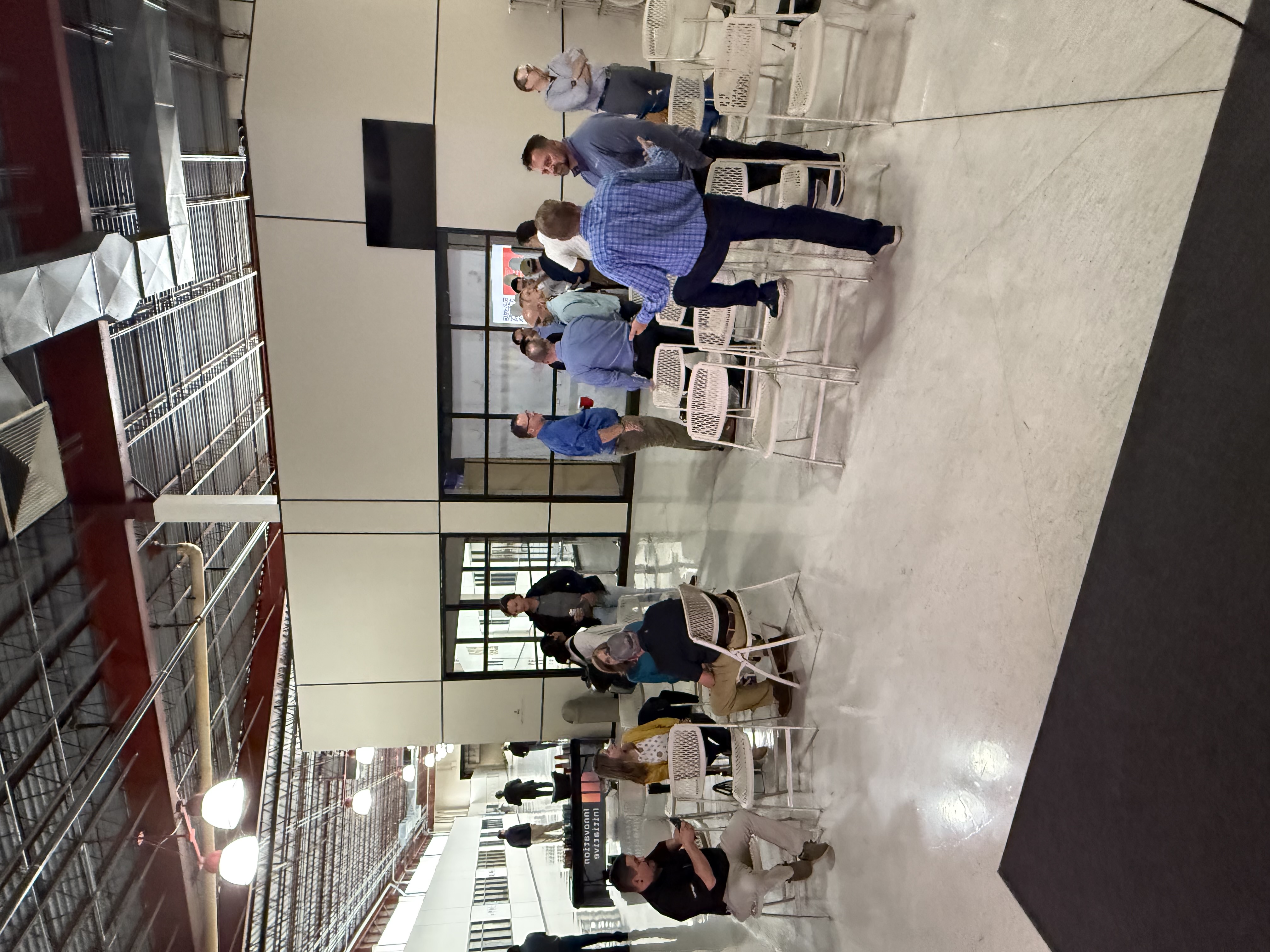 Attendees seated for a presentation in a warehouse venue