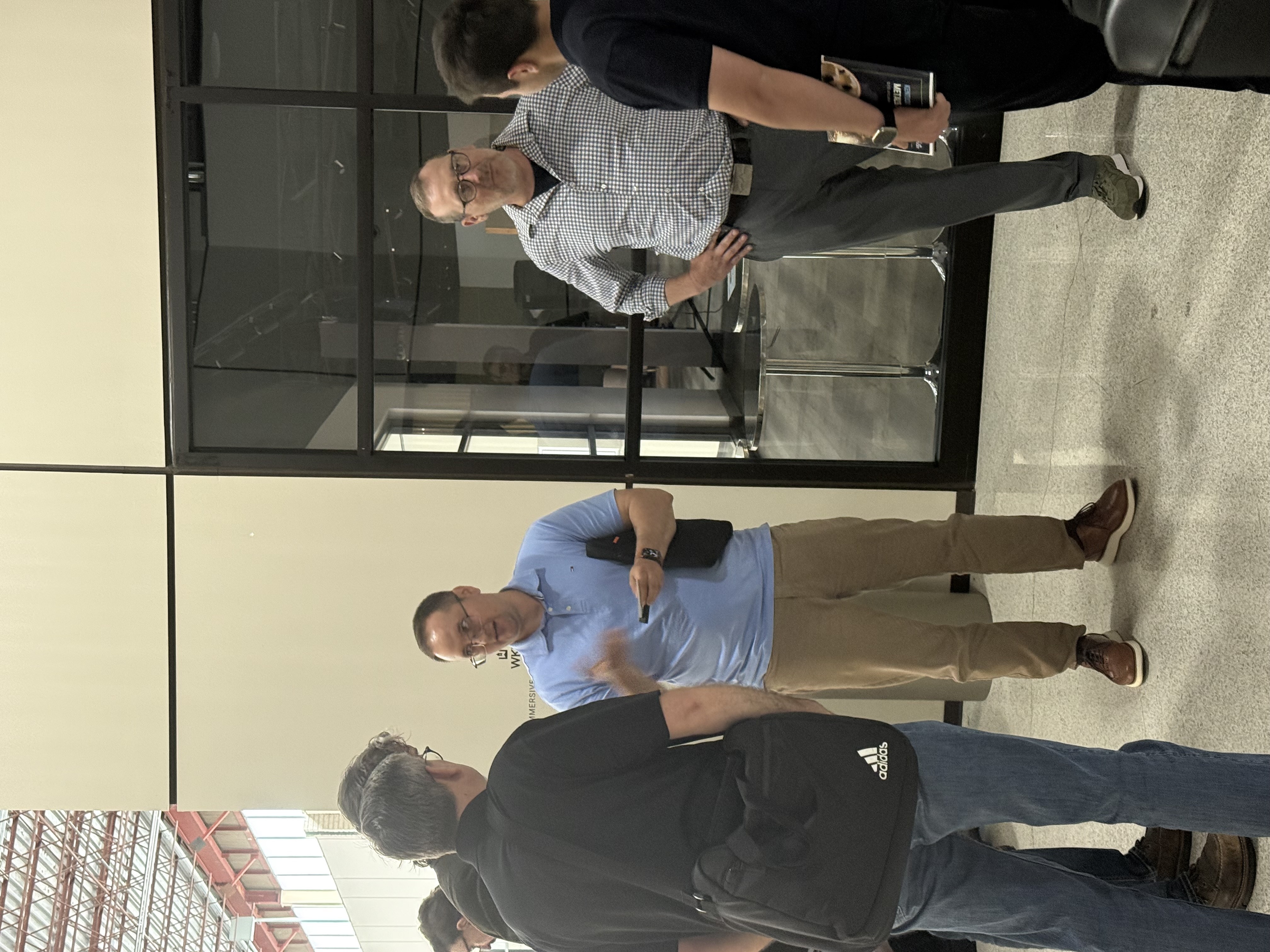 Group of attendees talking near event signage