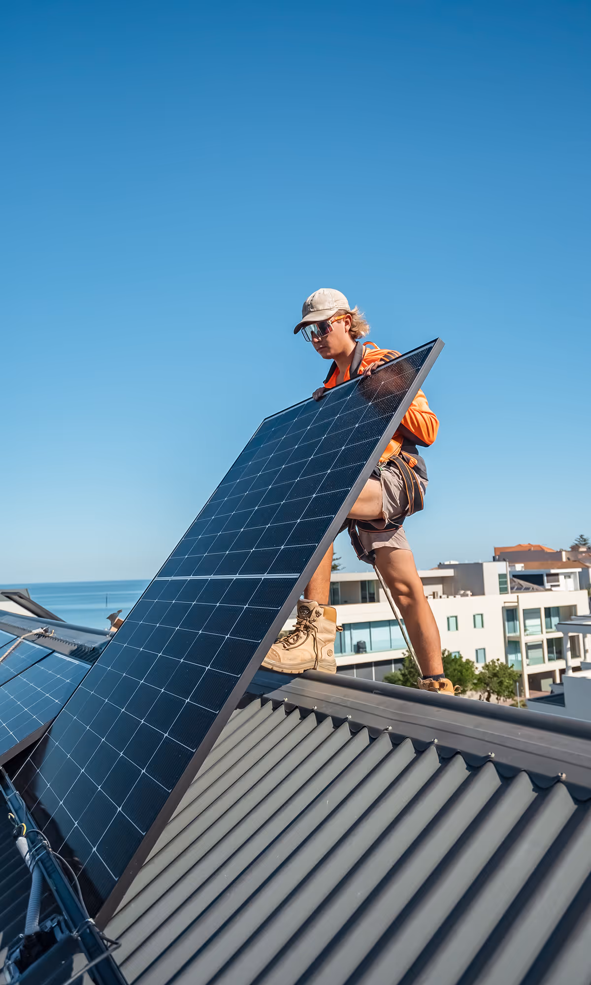 Worker-on-roof-with-solar-panel
