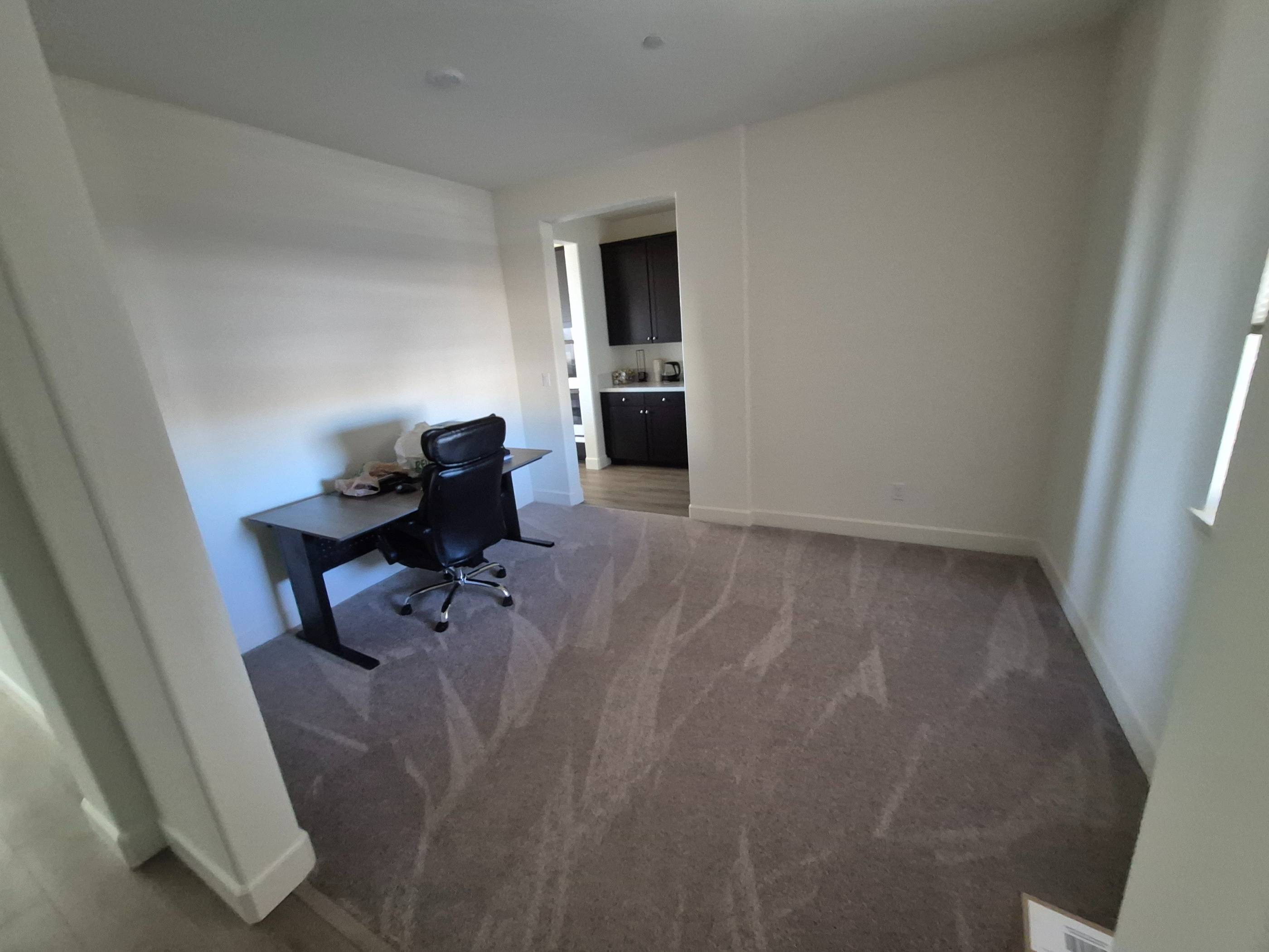 Home office that has noticeably just been vacuumed and cleaned