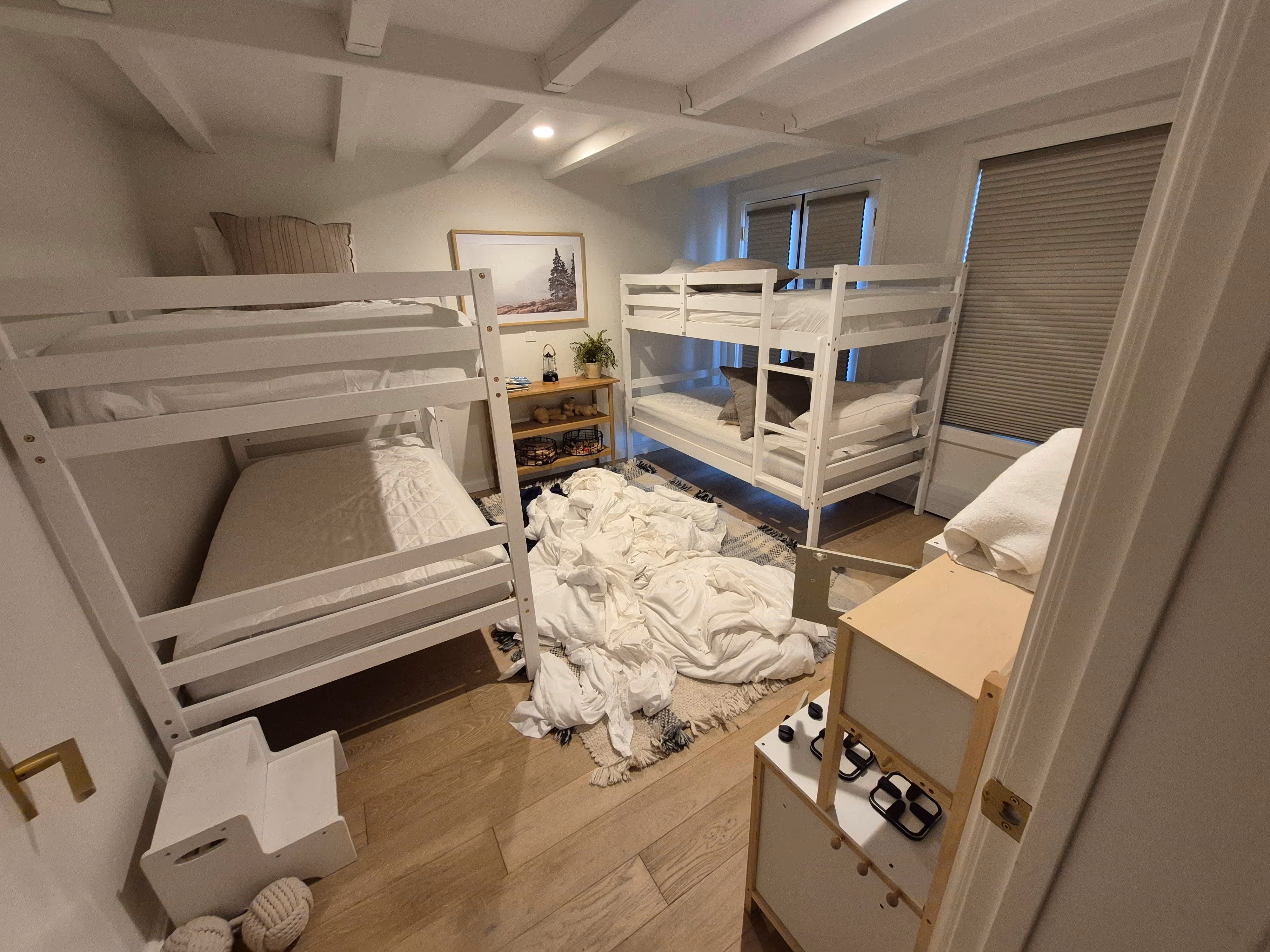 a bedroom with a lot of blankets on the ground and that is visibly dirty