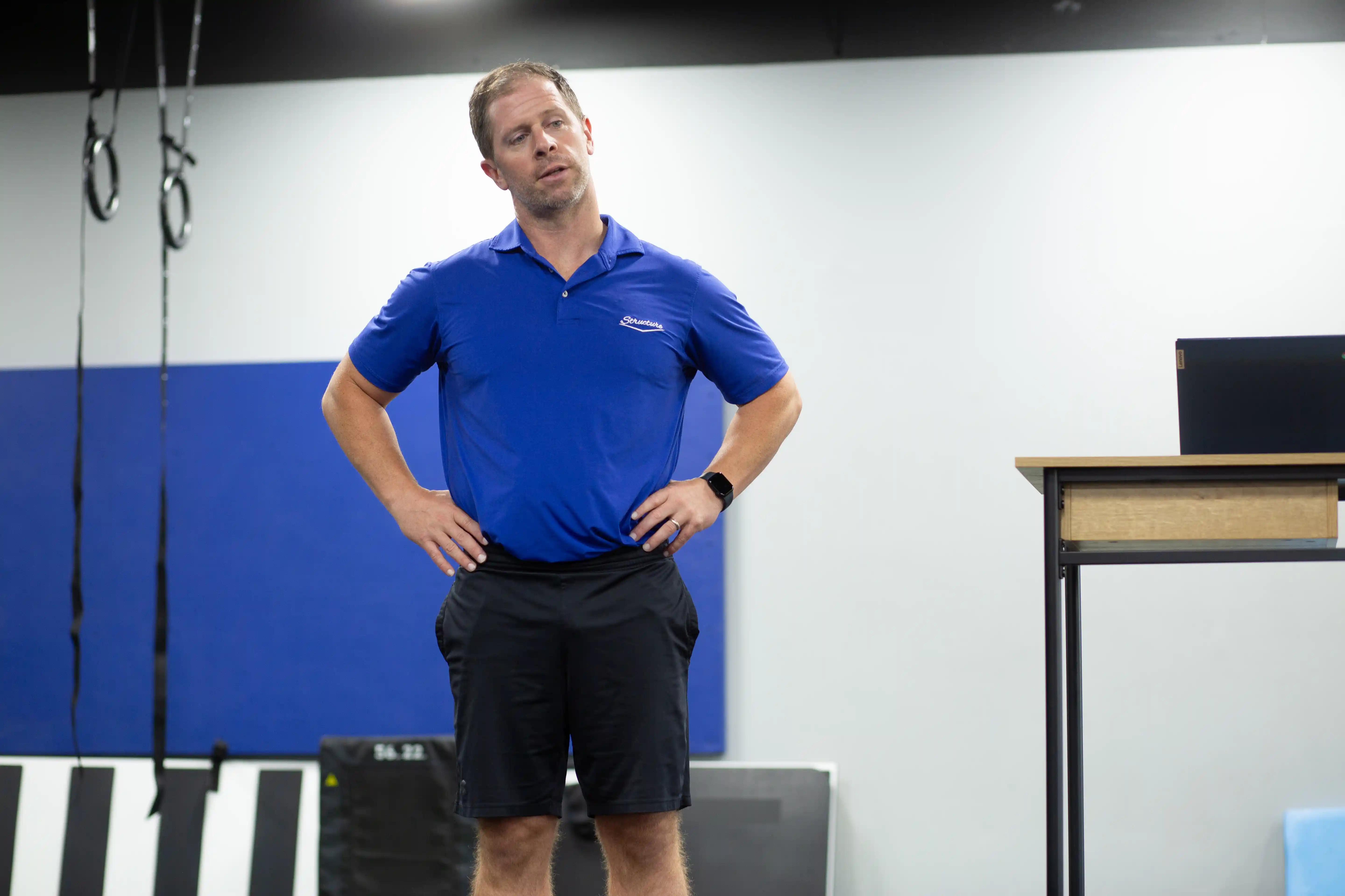 Kevin Dineen standing with arms spread, presenting a welcoming gesture at Structure PF.