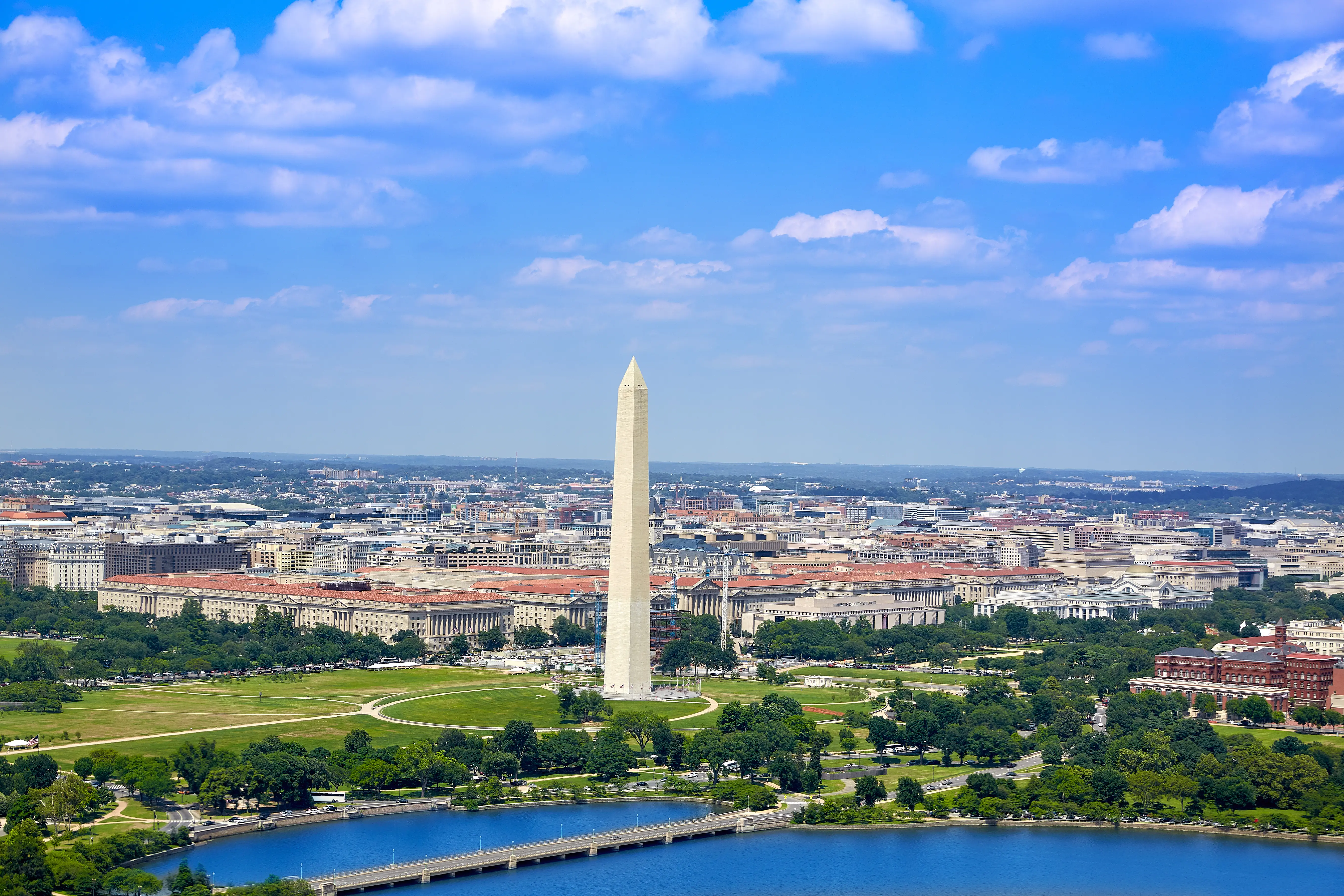 An aerial image of Washington DC looking at a body of water and the Washington memorial.