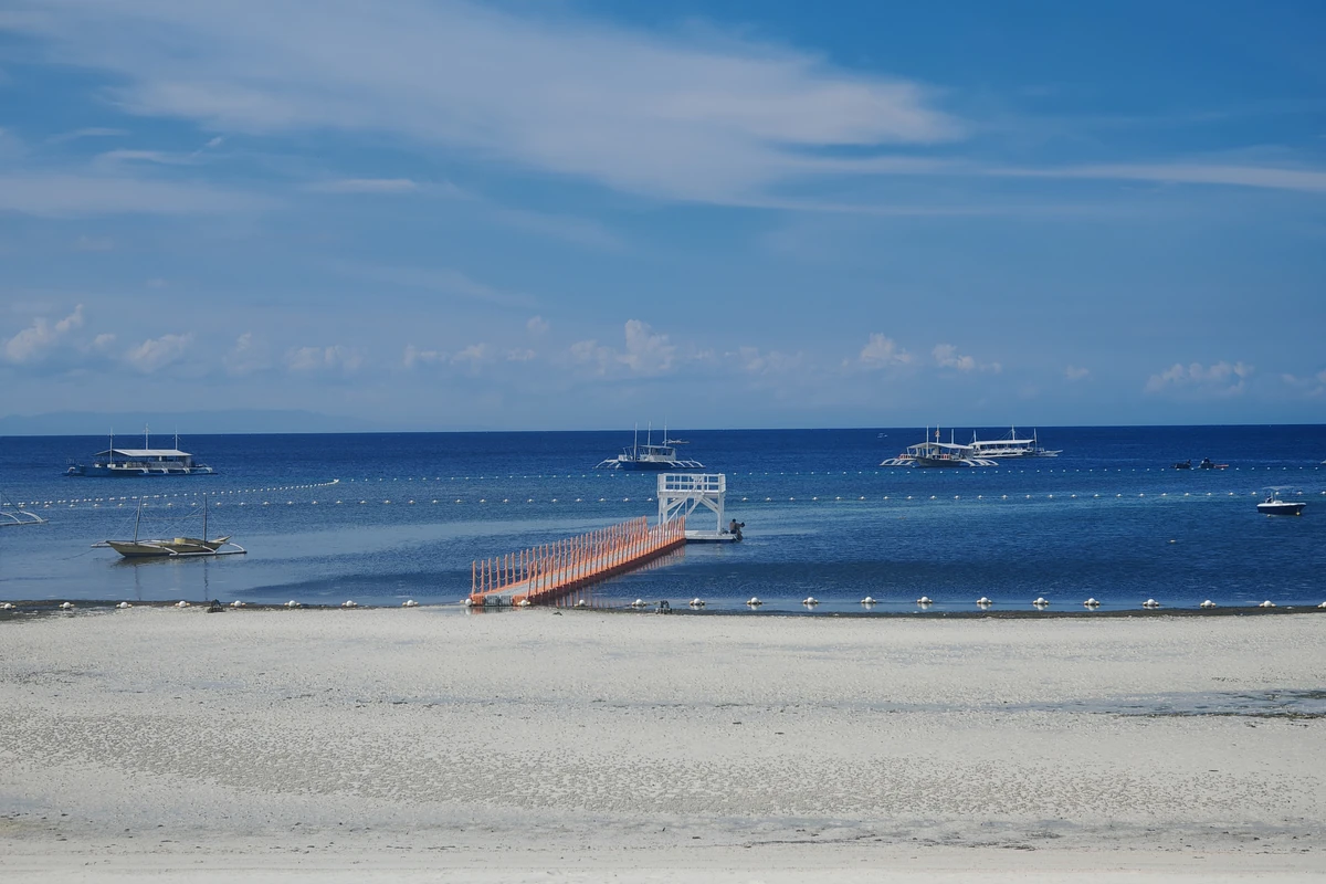 Quiet shoreline and boats at Doljo Beach in Panglao, Bohol