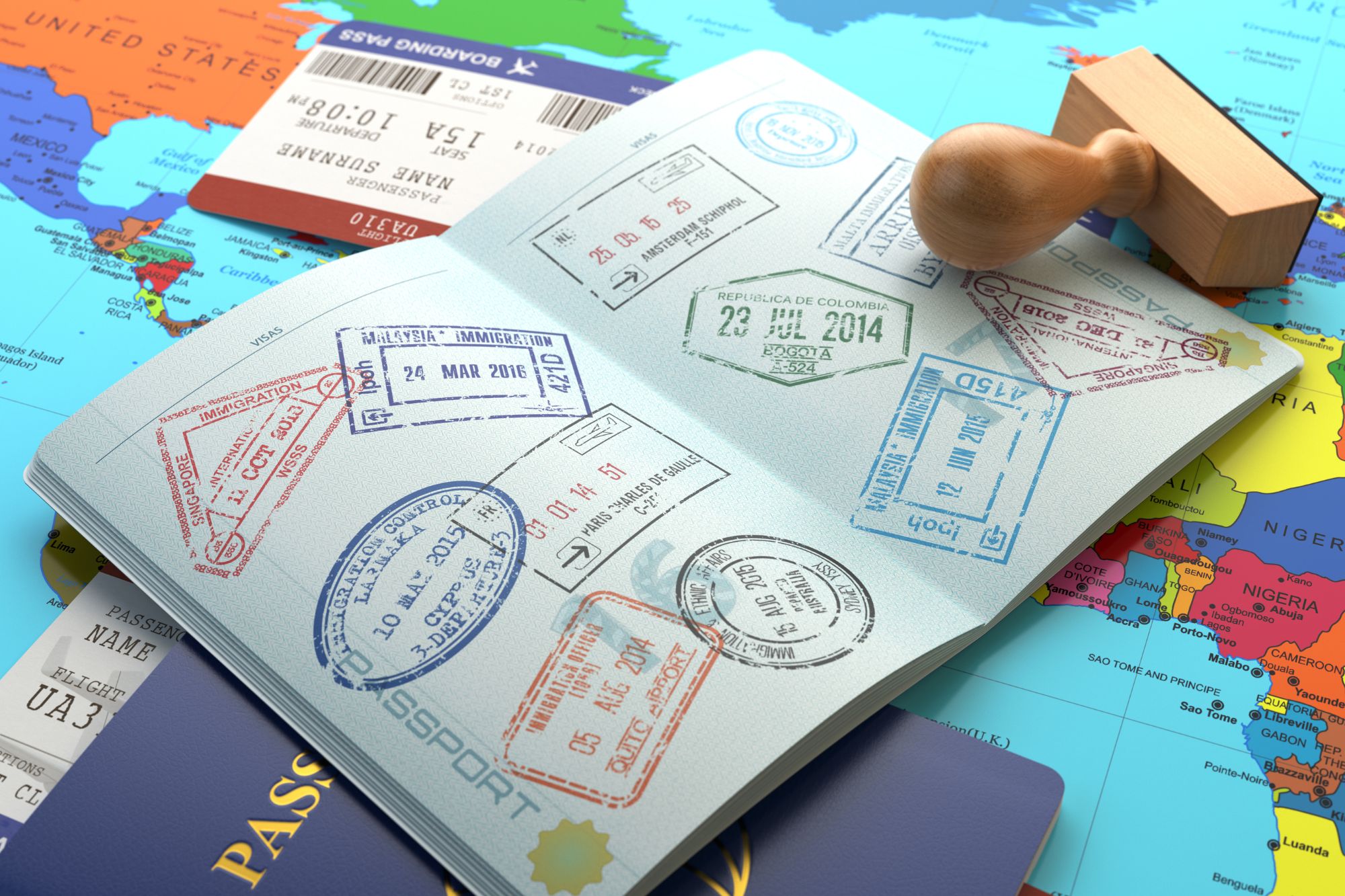 Open passport showing multiple international visa stamps placed on a colorful world map with a boarding pass and passport