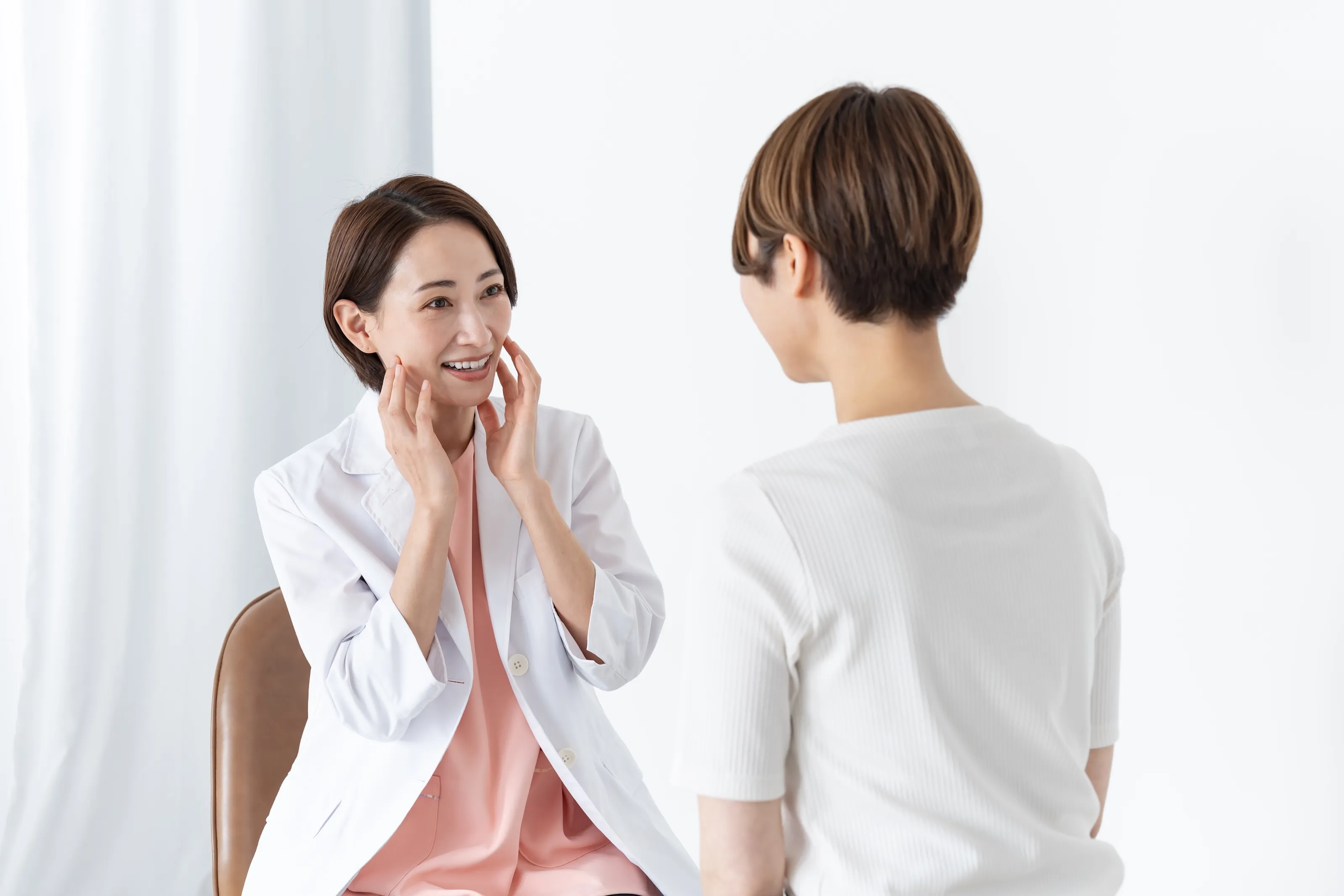 Dentist demonstrating jaw muscle areas to a patient during a Botox consultation at Omnia Modern Dentistry in Chino Hills CA