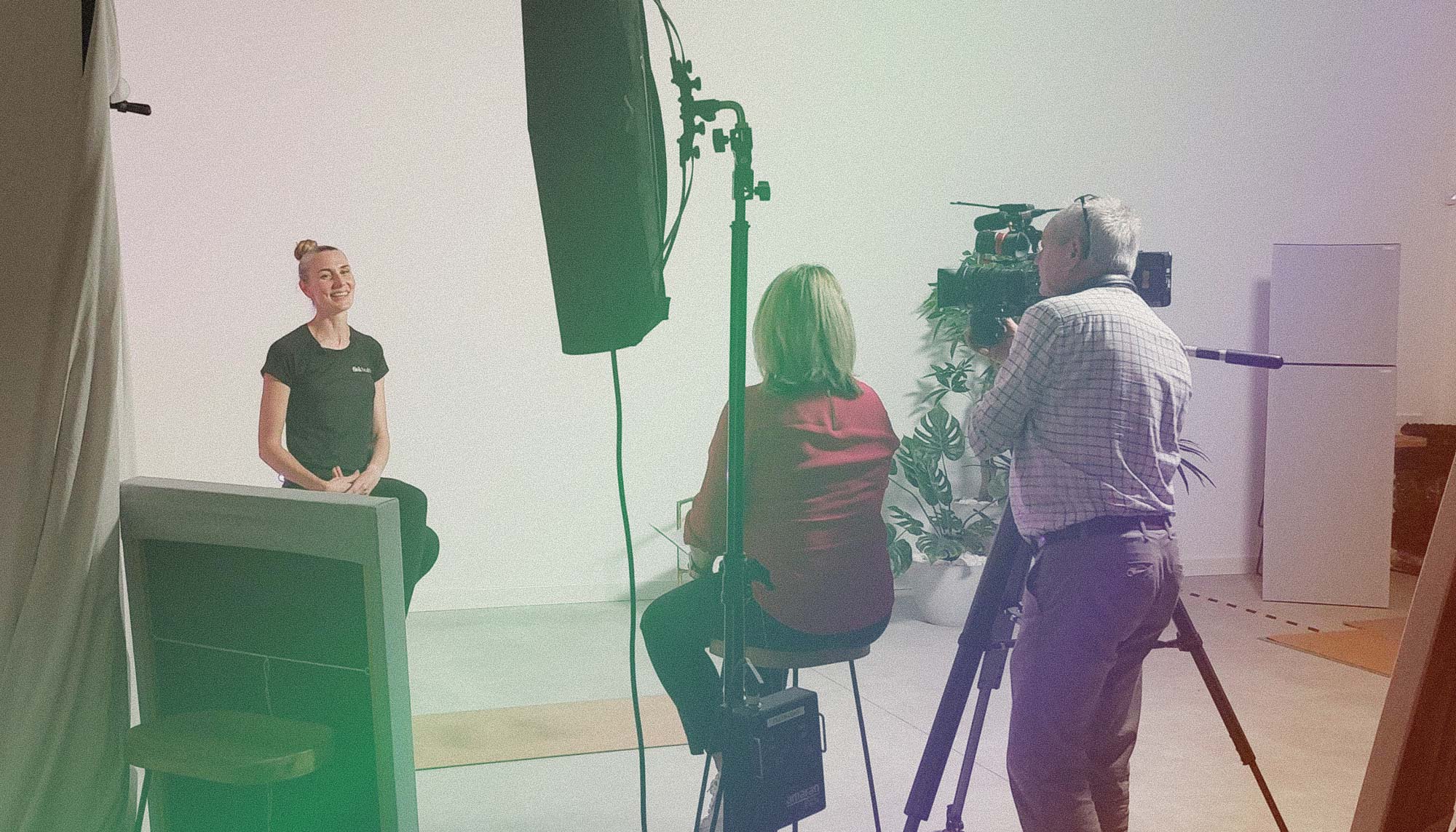 Kirsty, a Flok Health physiotherapist sitting in the filming studio.