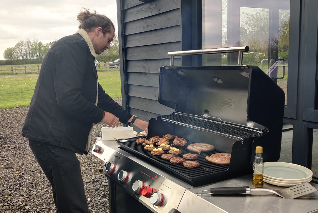 Finn Stevenson from Flok Health barbecuing outside the office. 