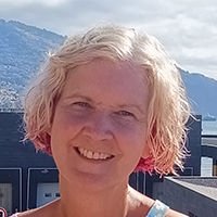 Sharon McMahon smiling with a short blonde bob