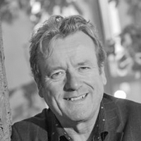 Ian Roberts smiling wearing a smart shirt