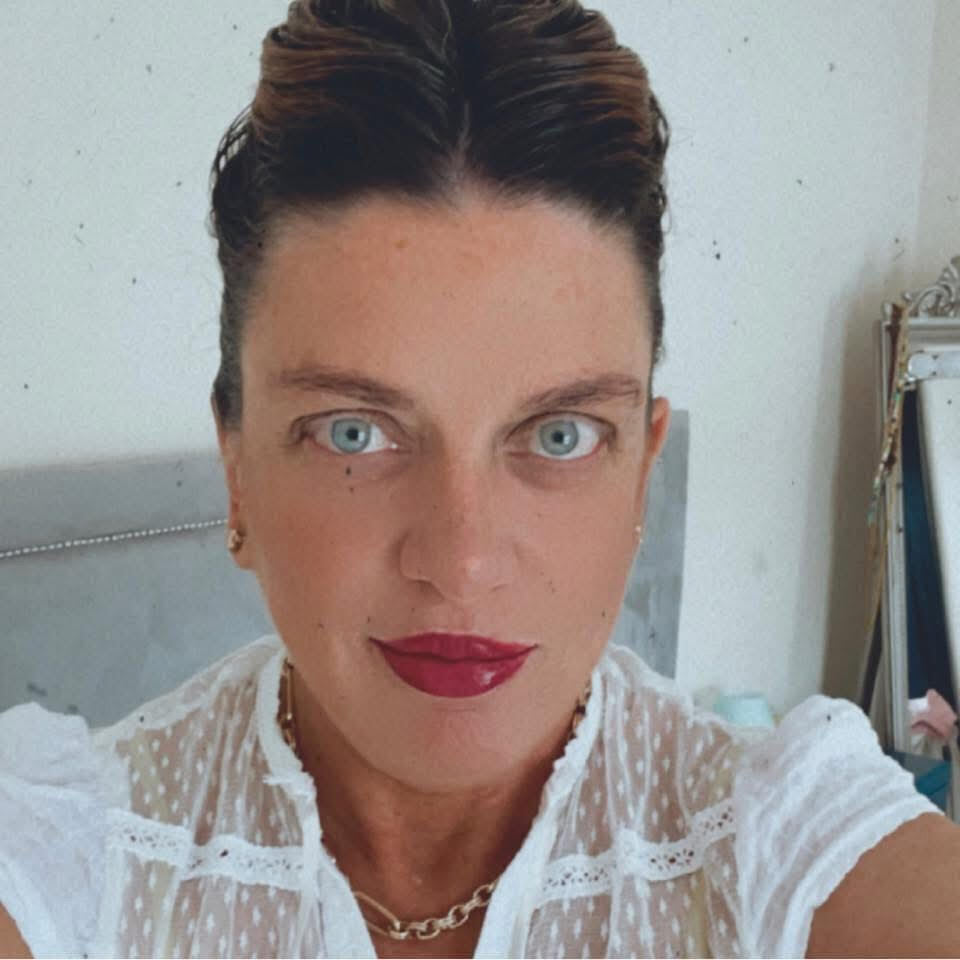 Tara O'Brien with striking blue eyes and brunette hair.