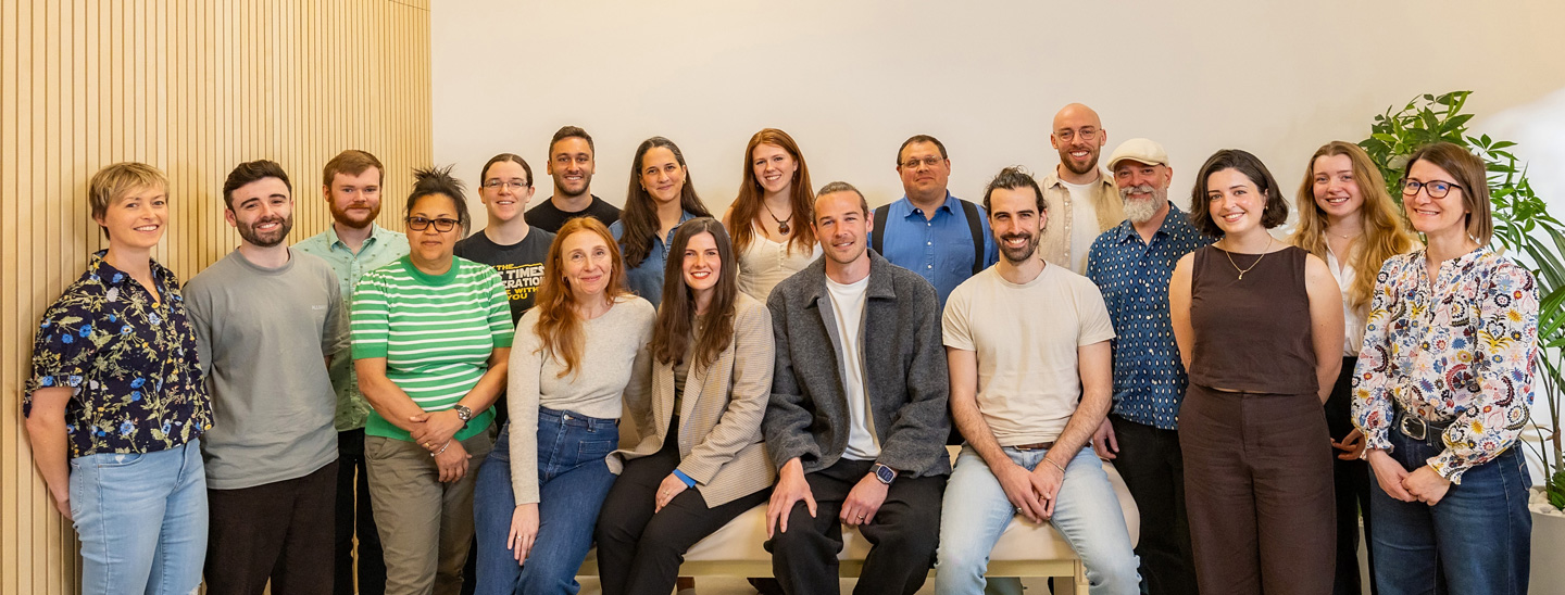 Flok Health team standing and sitting closely together