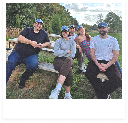 Team photo of Flok Health employees wearing matching caps