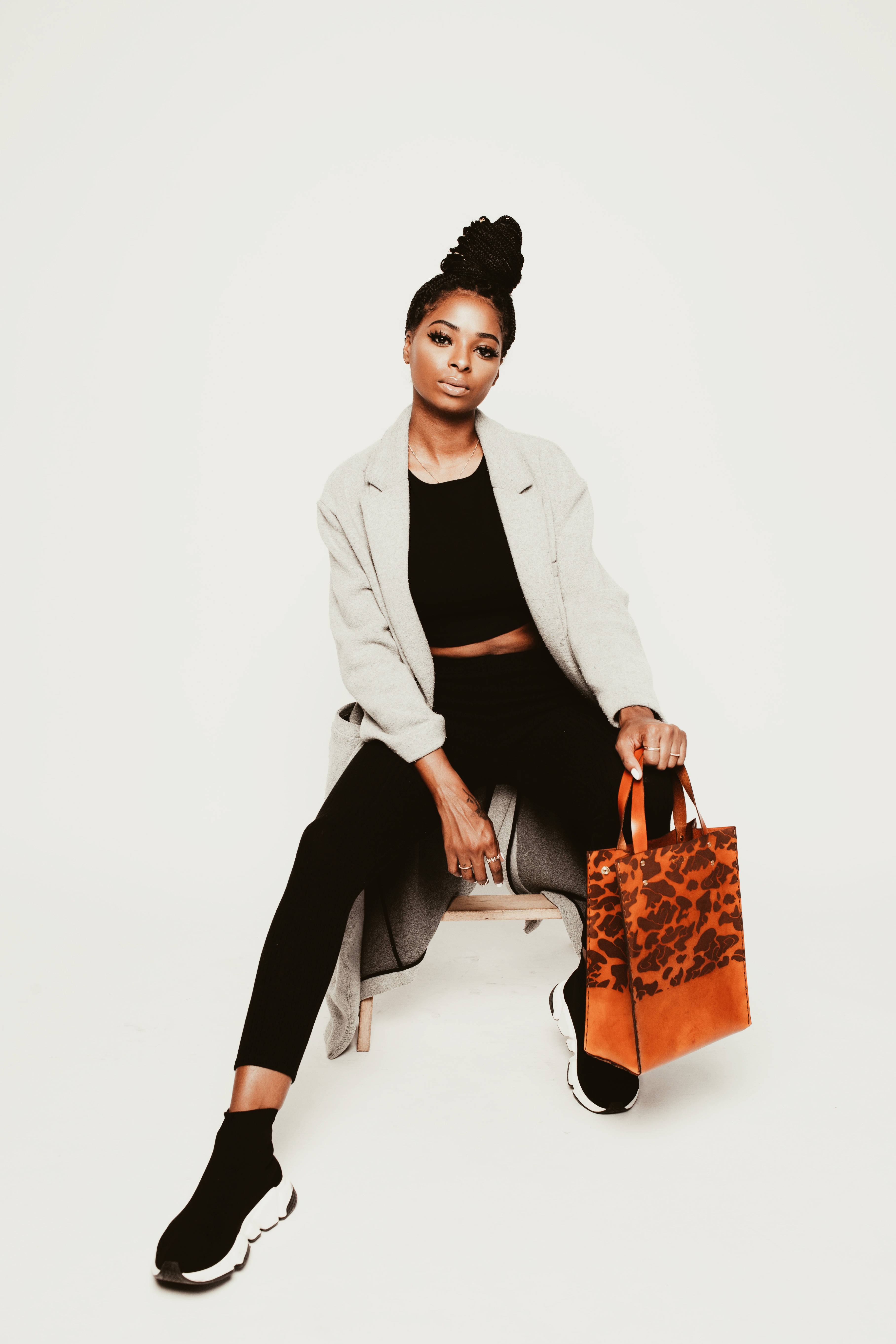 A photo of a woman wearing a SUNDRIES camo tote. 