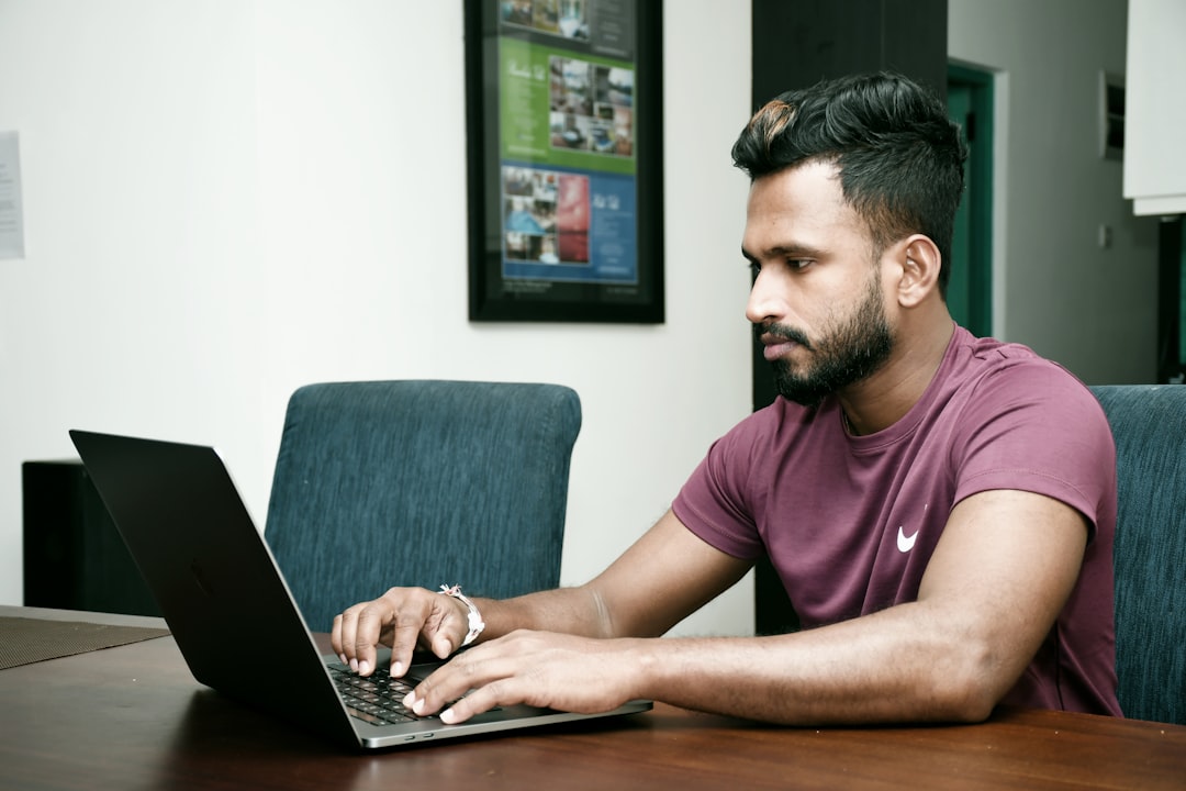 small business owner working on laptop - payroll companies for small business
