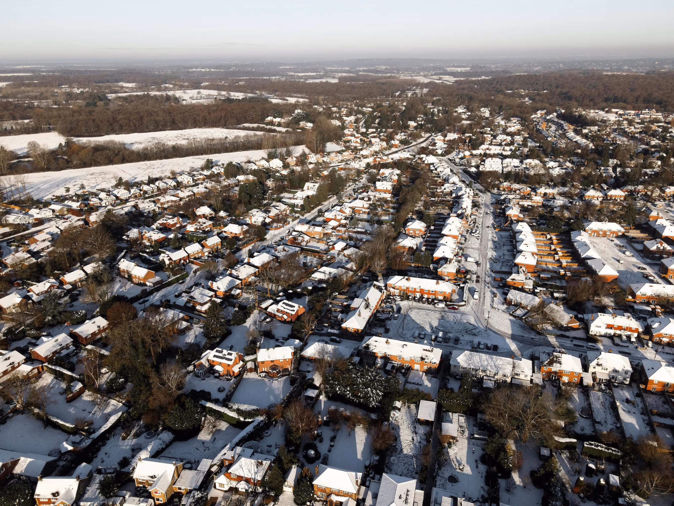 Suburb in the winter (snow covers rooftops)