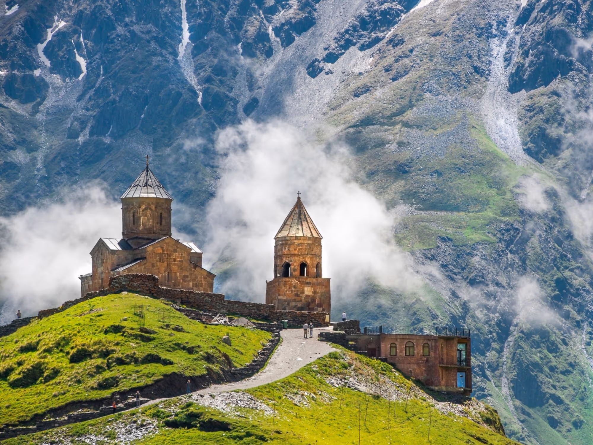 A landscape image of Gergeti Trinity Church in Georgia in the Caucasus  mountains.