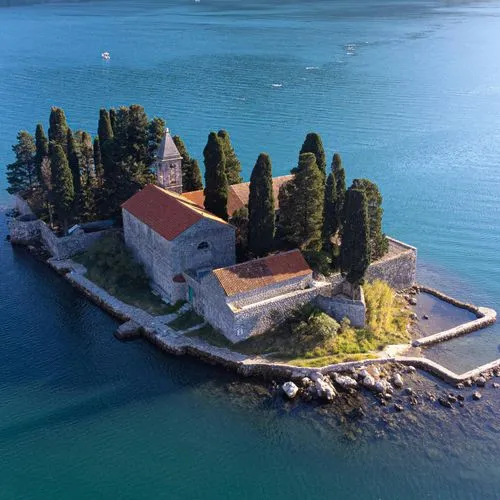 Montenegro Islet - A small island with a stone church and cypress trees in the Bay of Kotor.