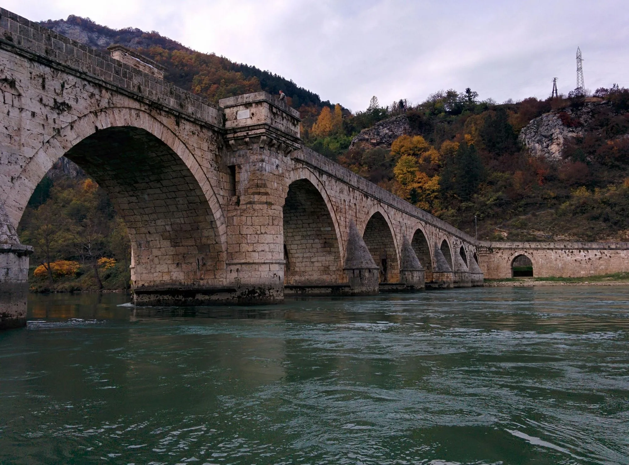 The Mehmed Paša Sokolović Bridge in Višegrad, Bosnia, a historic Ottoman stone bridge spanning the Drina River.