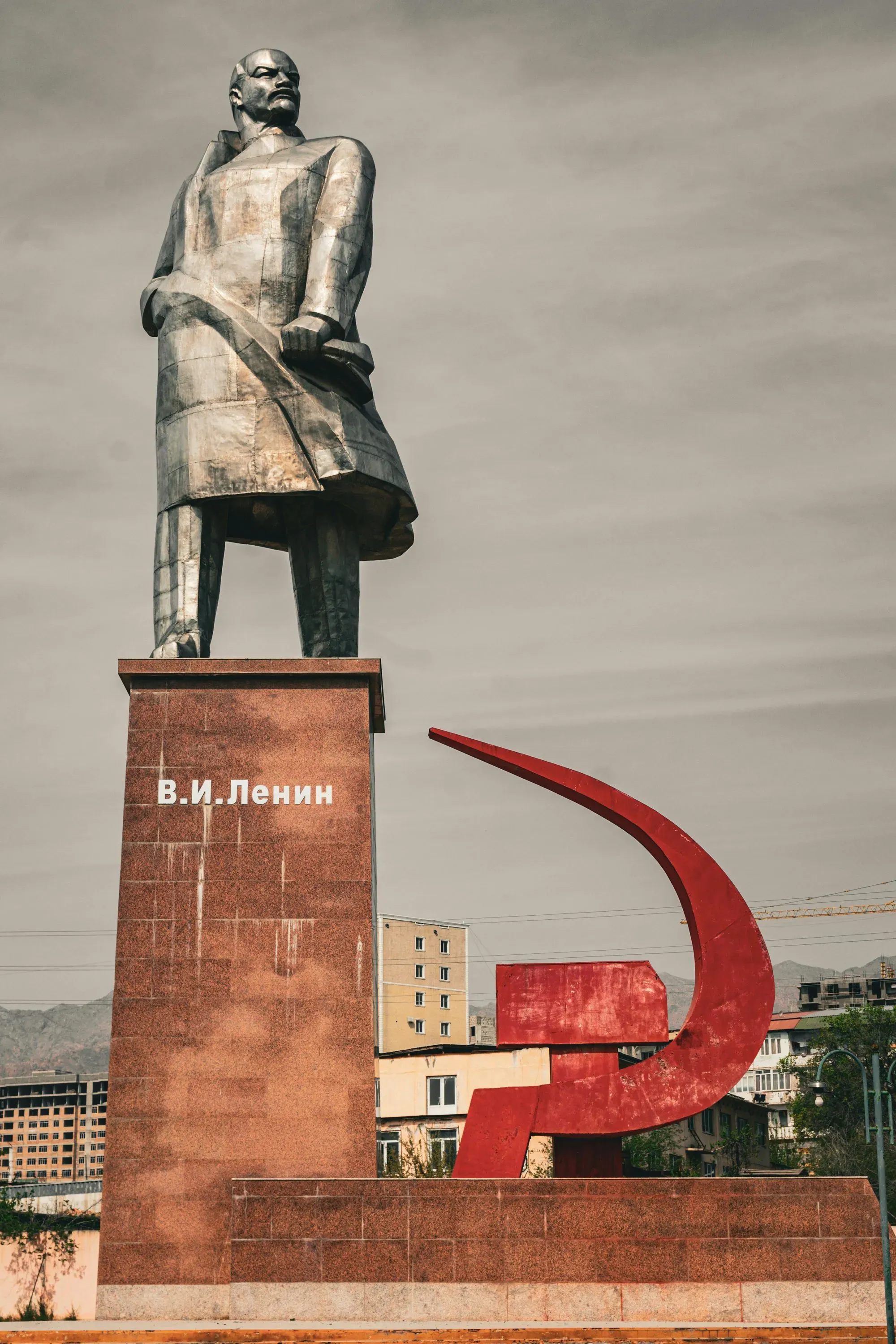 The Lenin statue in Khujand, Tajikistan, a Soviet-era monument with a striking red pedestal.