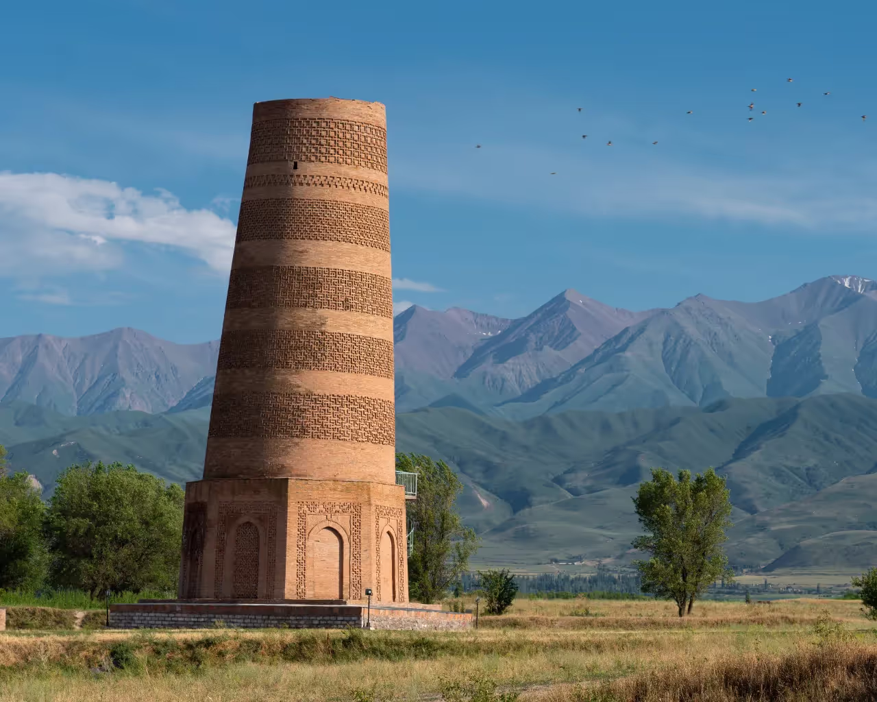 Kyrgyzstan Burana Tower - Ancient Burana Tower standing tall against the mountain landscape of Kyrgyzstan.