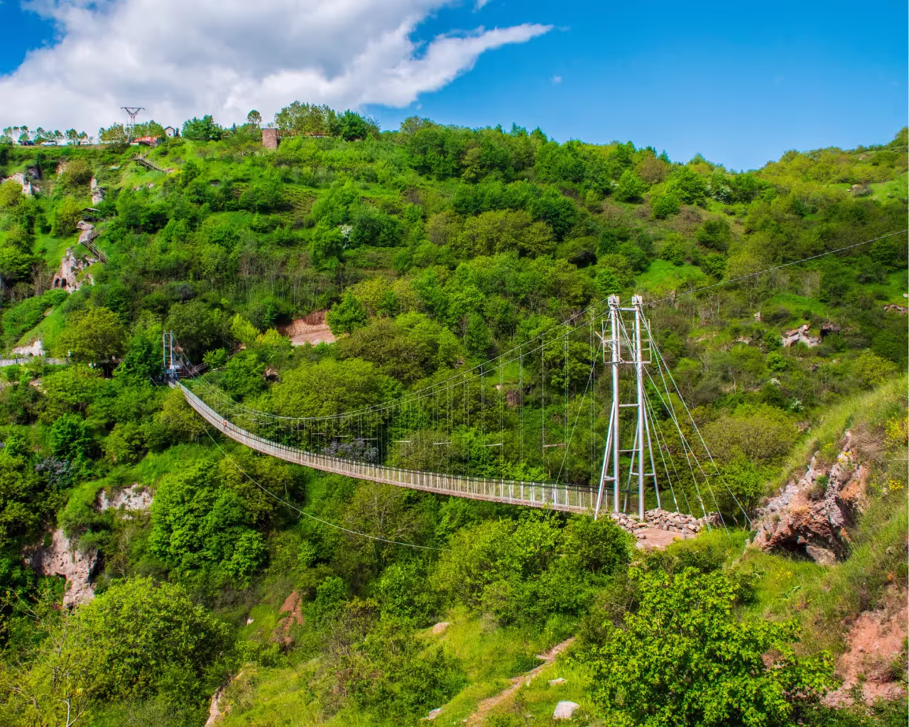 Khndzoresk Swinging Bridge in Armenia connecting ancient cave dwellings.