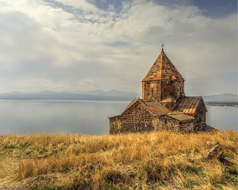 The historic Sevanavank Monastery on a hill overlooking the serene waters of Lake Sevan, Armenia.