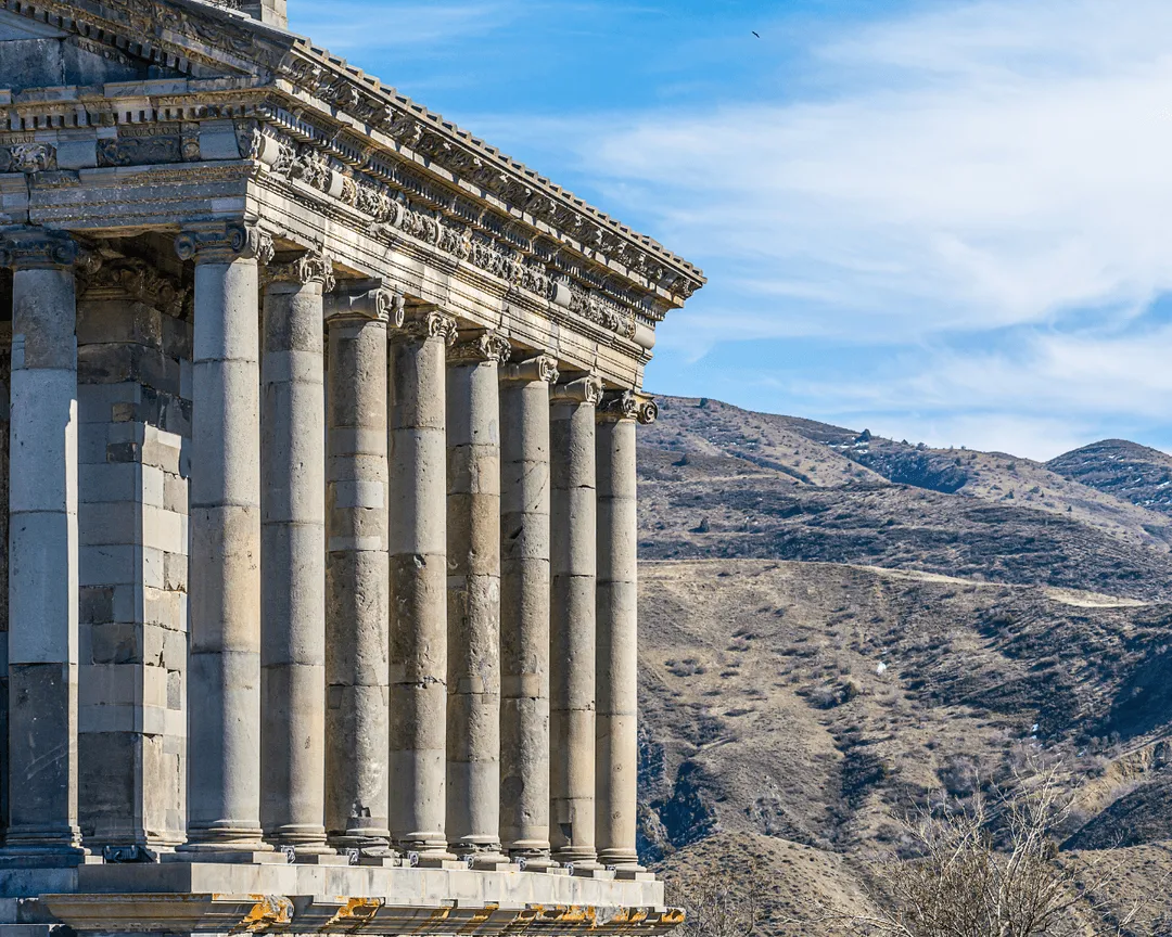 The Garni Temple in Armenia, an ancient Greco-Roman pagan temple set against a mountainous backdrop.