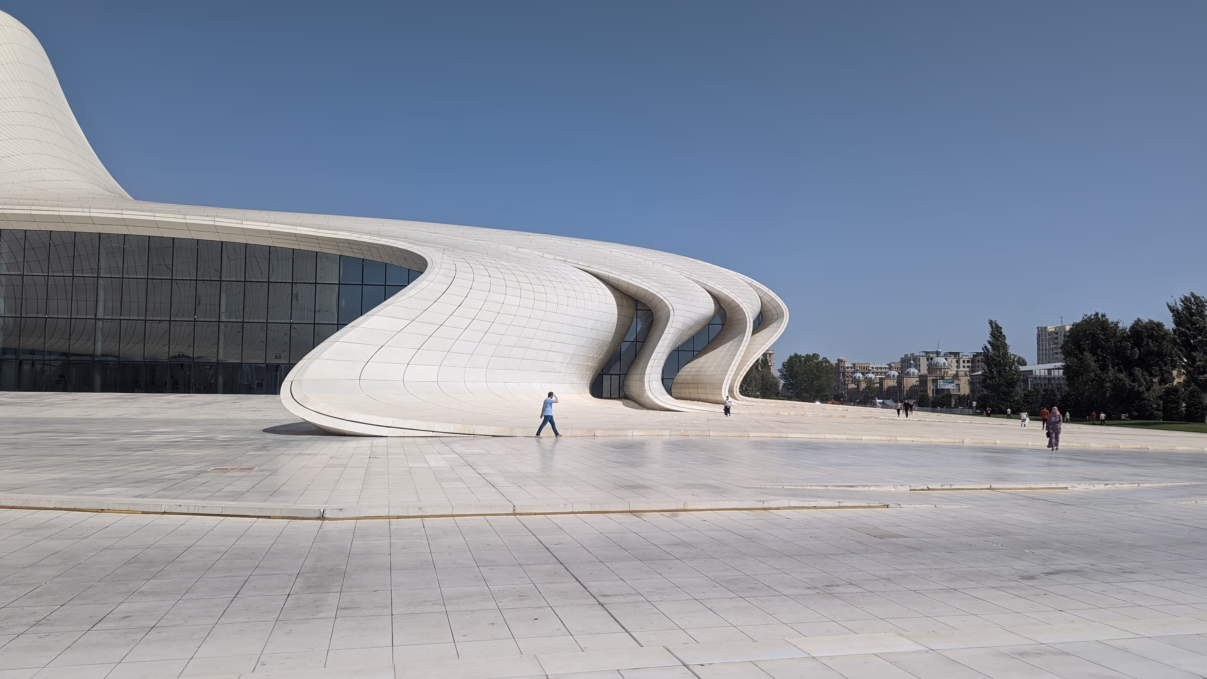 The futuristic Heydar Aliyev Center in Baku, Azerbaijan, with its curved white architecture and open plaza.