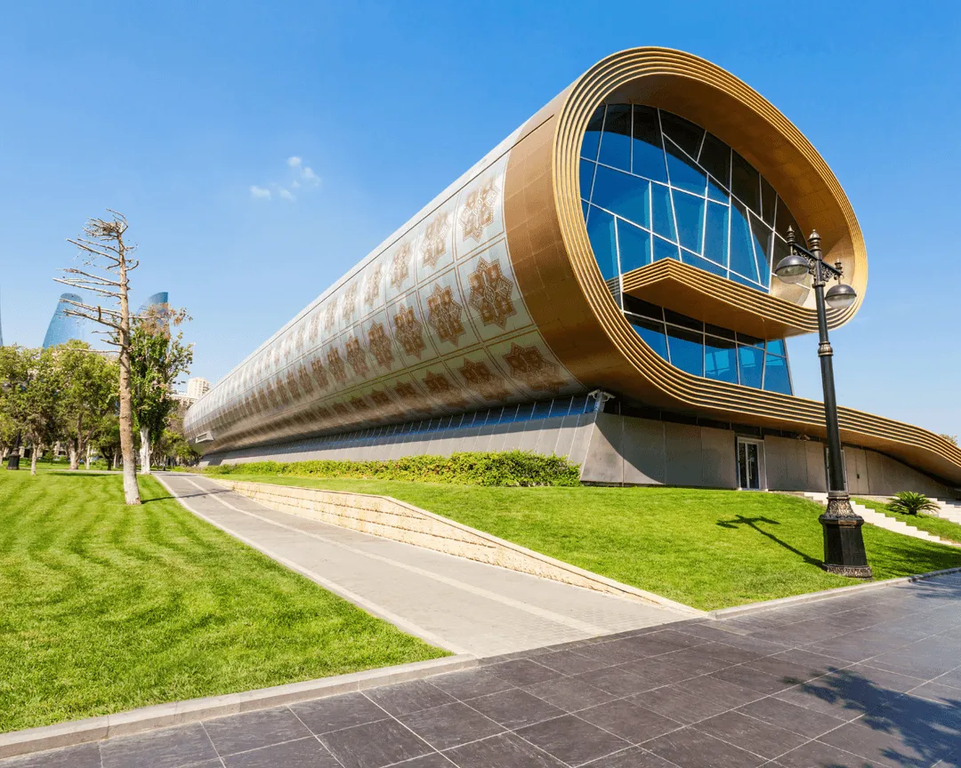 Azerbaijan Carpet Museum in Baku, a uniquely curved building resembling a rolled-up carpet with intricate patterns.
