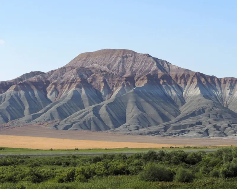 Stunning striped mountains in Azerbaijan, with layers of red, green and beige hues creating a unique geological pattern.