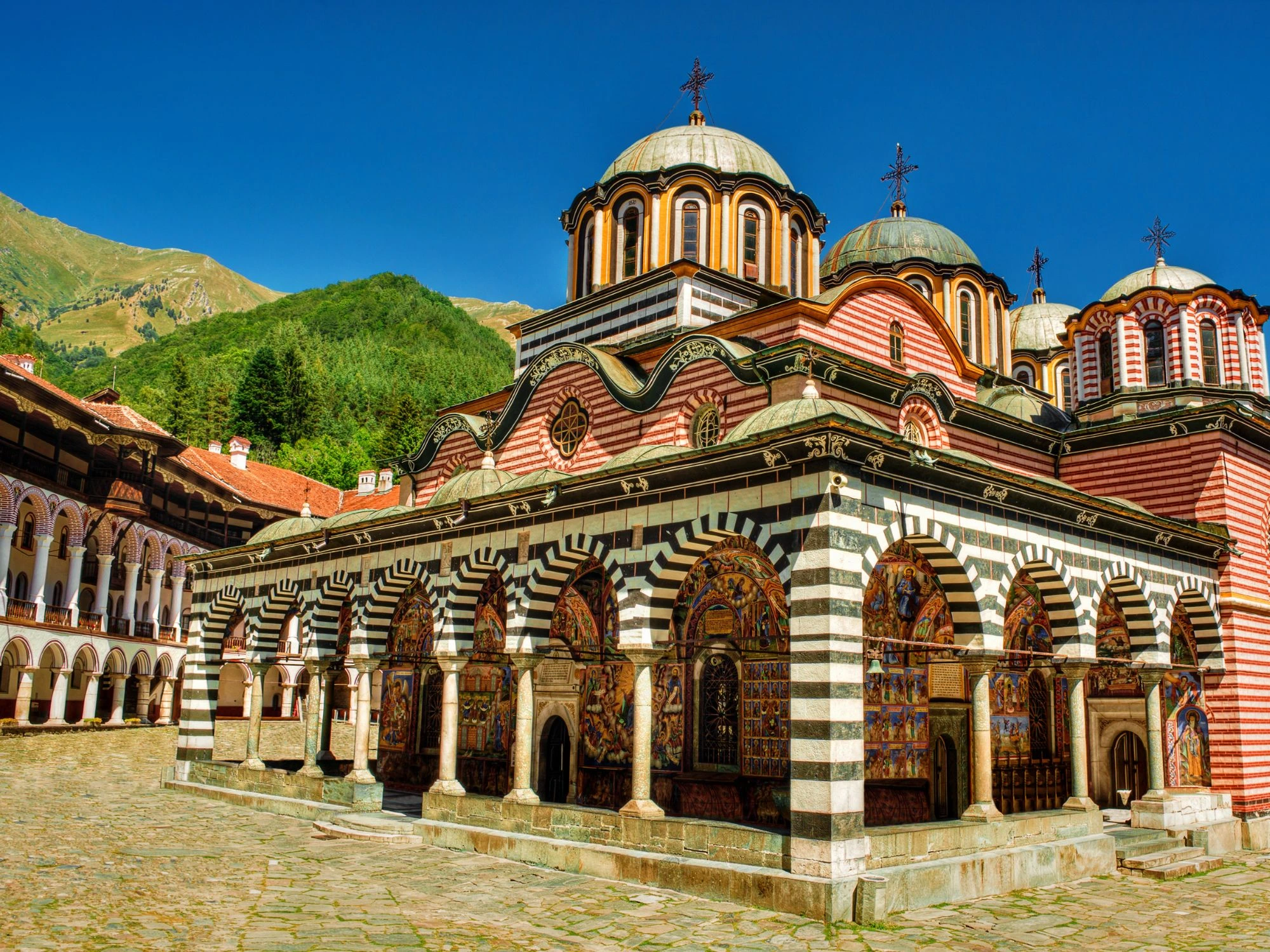 Rila Monastery’s striped arches and domes set against a mountainous backdrop.