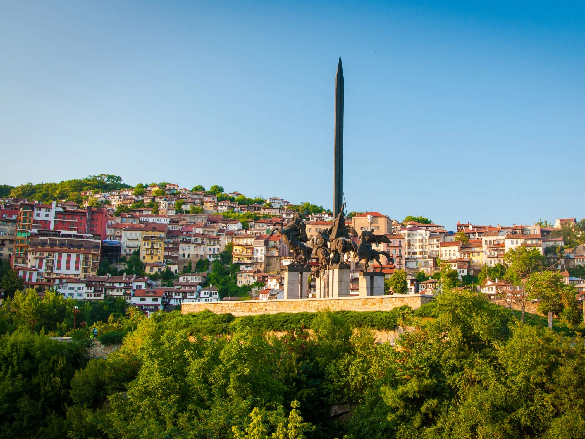 Monument of Asenevtsi Kings in Veliko Tarnovo with colorful hillside houses