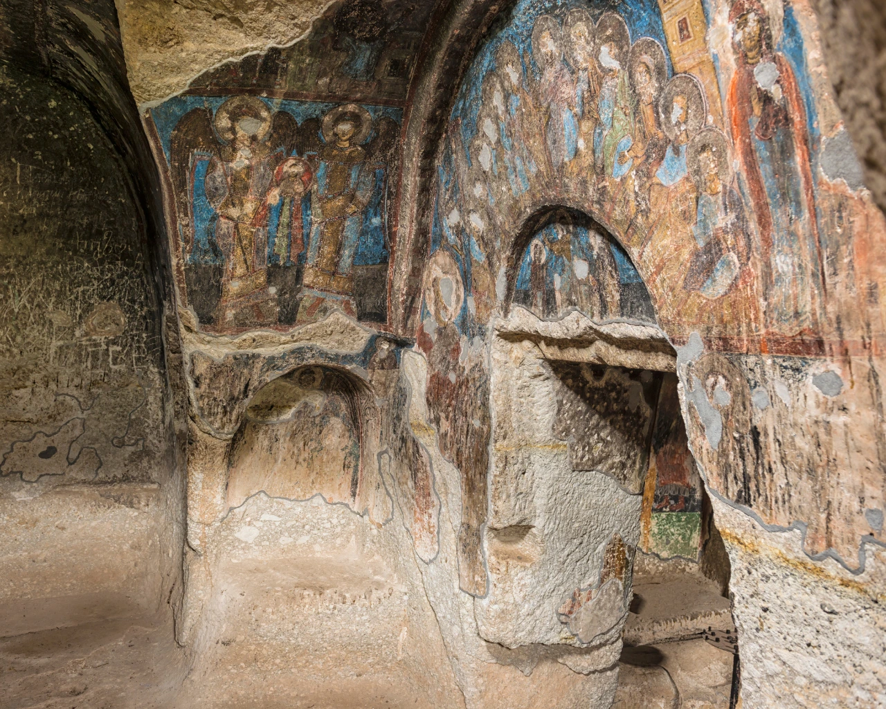Vardzia Monastery Frescoes, Georgia - Ancient frescoes inside Vardzia cave monastery depicting religious figures.