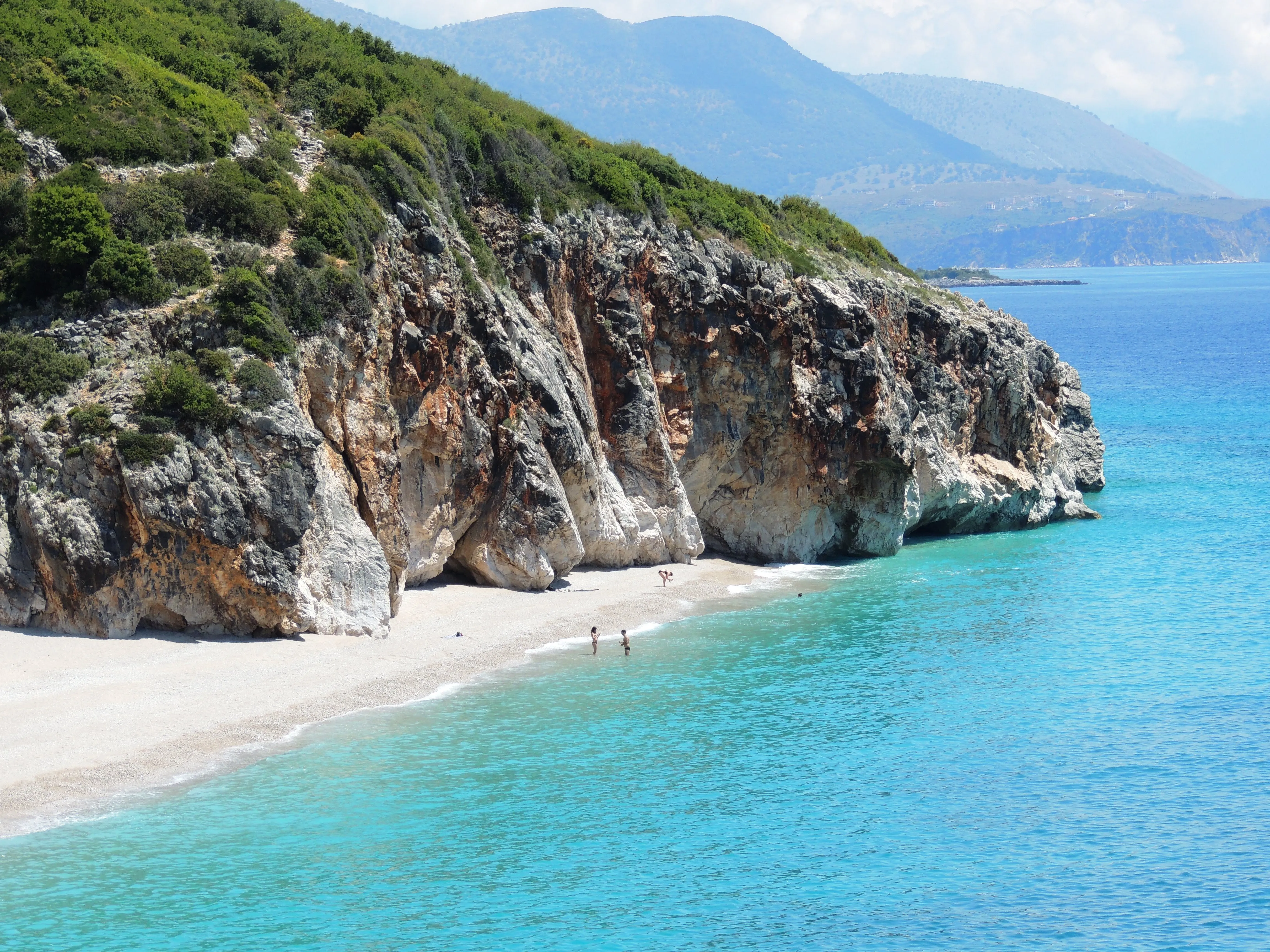 Hidden beach with turquoise waters and dramatic cliffs, a perfect secluded getaway on the Albanian coast.