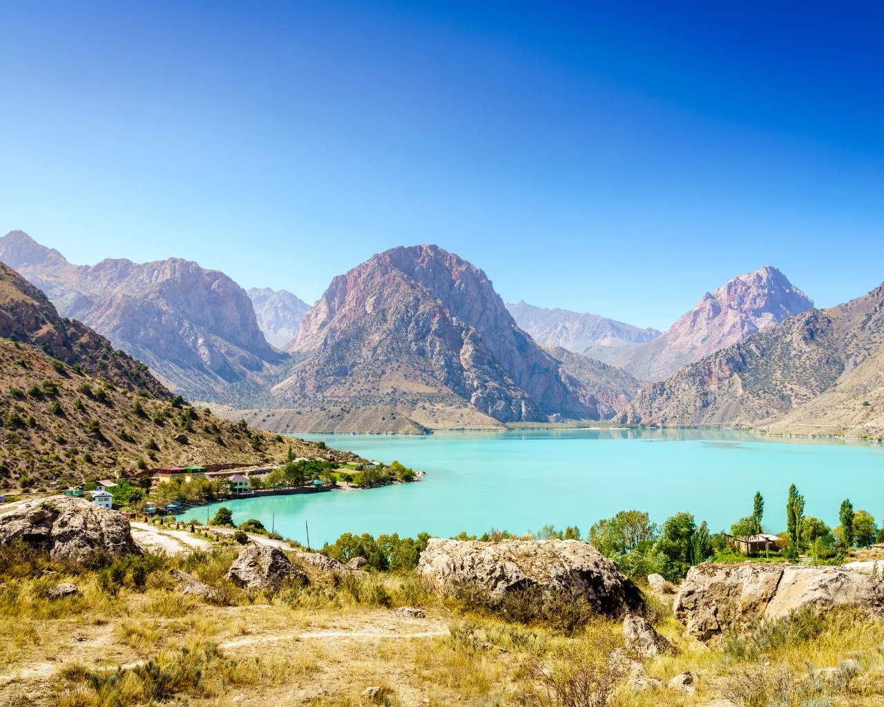 Iskanderkul, Tajikistan: A stunning alpine lake with blue waters reflects the surrounding rocky peaks.