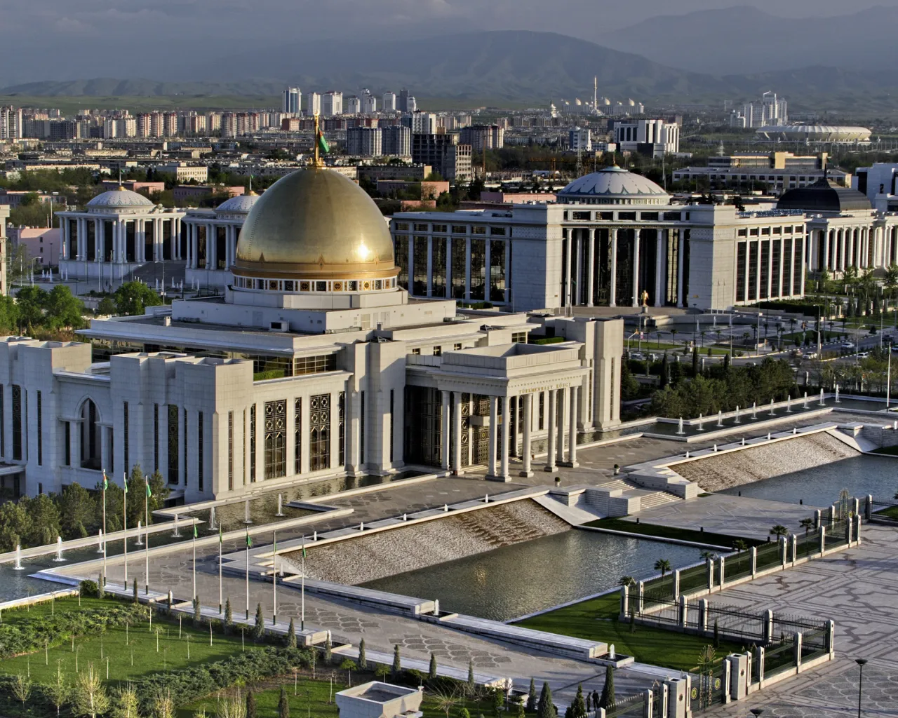 Turkmenistan Presidential Palace with cityscape of Ashgabat in the background.