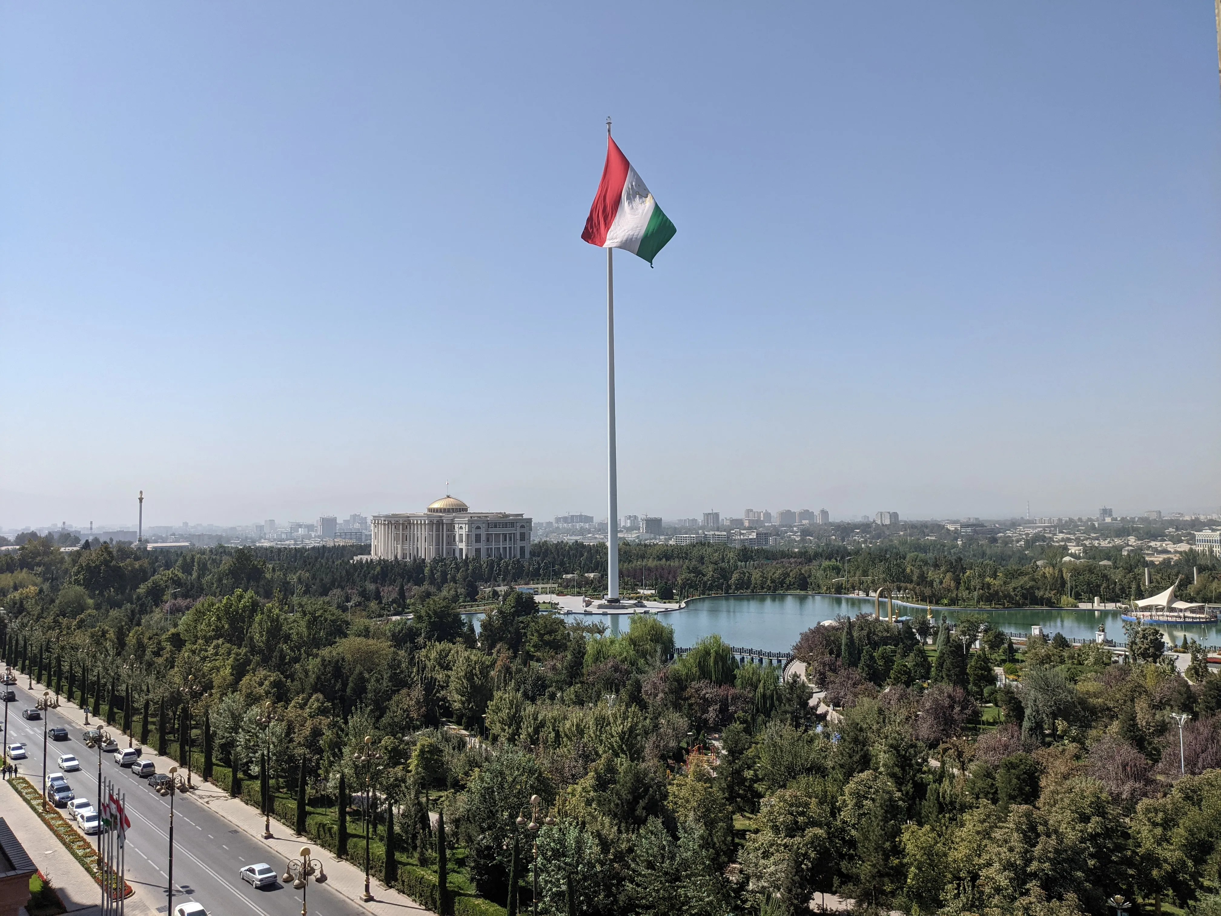 Dushanbe, Tajikistan: The national flag soars over the cityscape, with the Presidential Palace and greenery below.