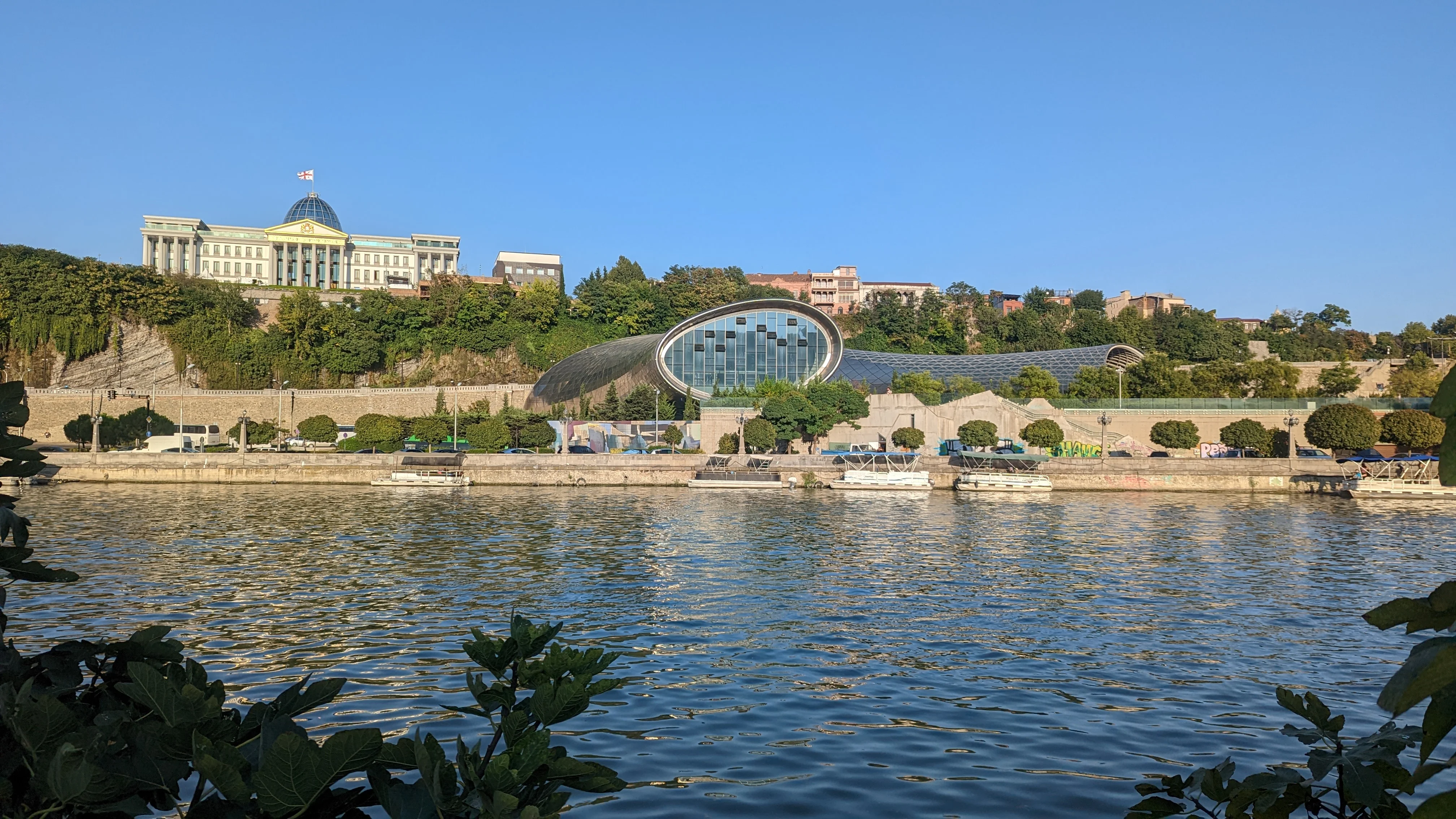 Modern architecture and the Georgian Presidential Palace along the Mtkvari River in Tbilisi.