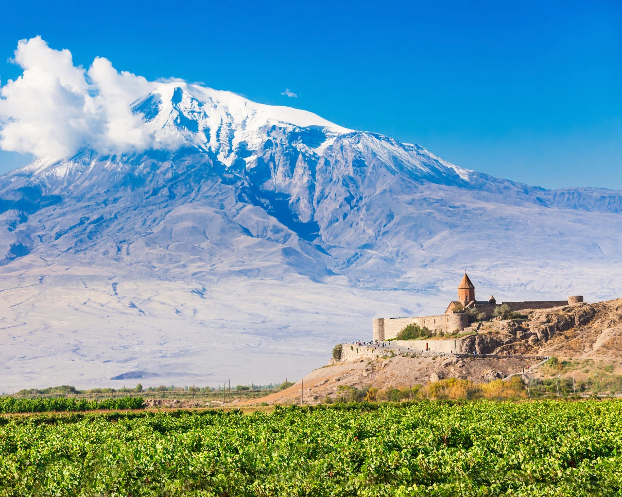 Khor Virap Monastery with Mount Ararat in the background under a clear blue sky.