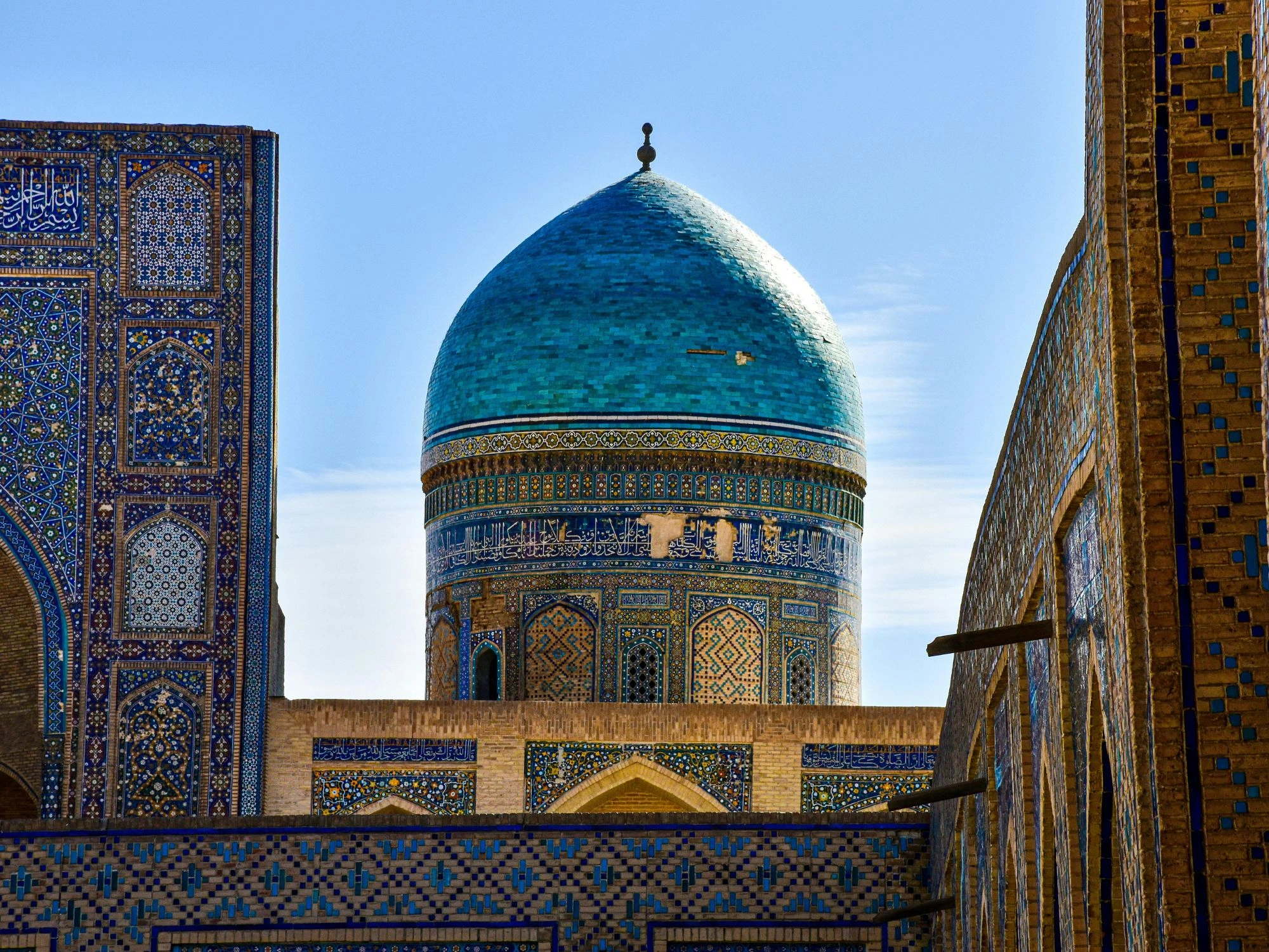Blue domed mosque and intricate tilework in the historic city of Bukhara, Uzbekistan.
