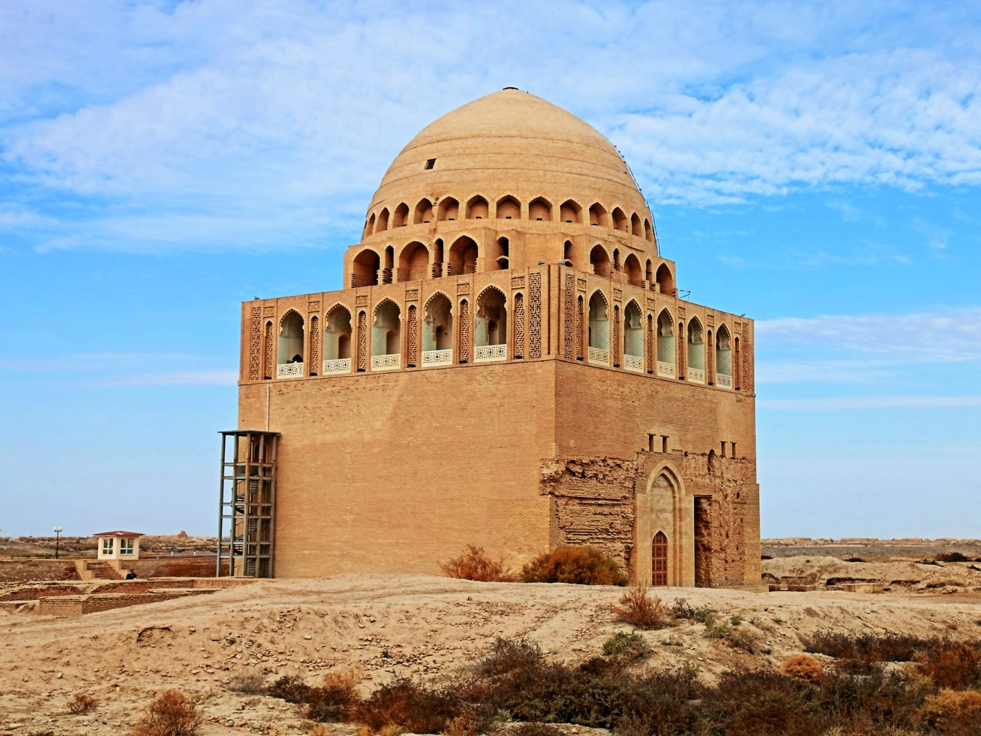 Tomb of Sultan Sanjar in Merv, Turkmenistan, with a grand dome and intricate archways.