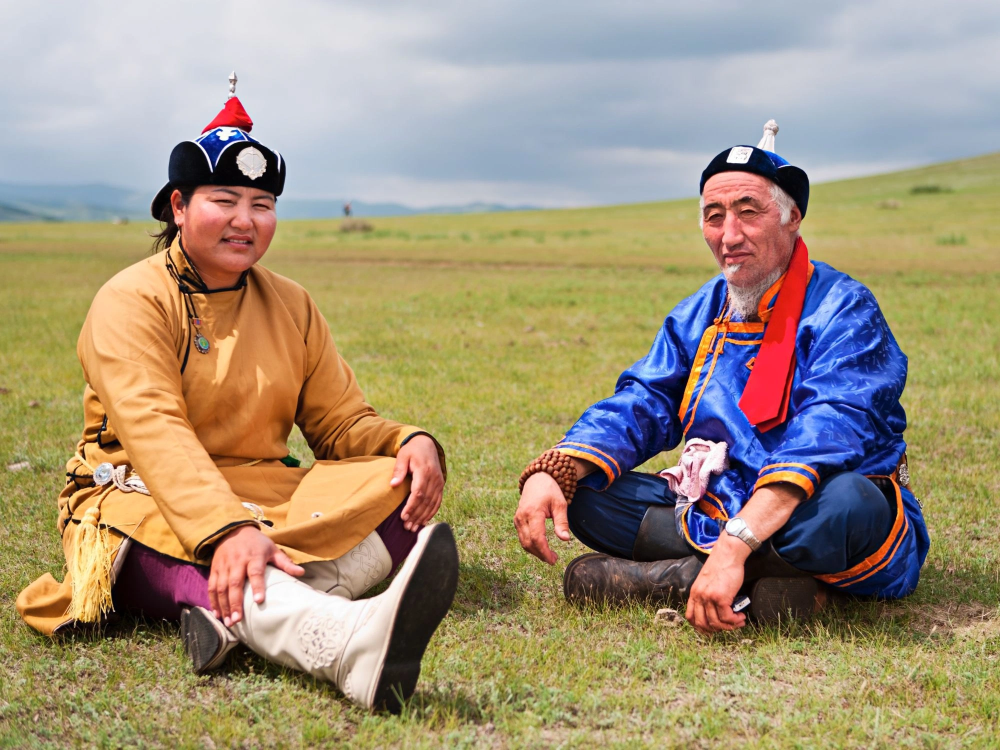 Two wrestlers at Mongolia’s Naadam festival, dressed in traditional gear, showing Mongolian sports culture travel.