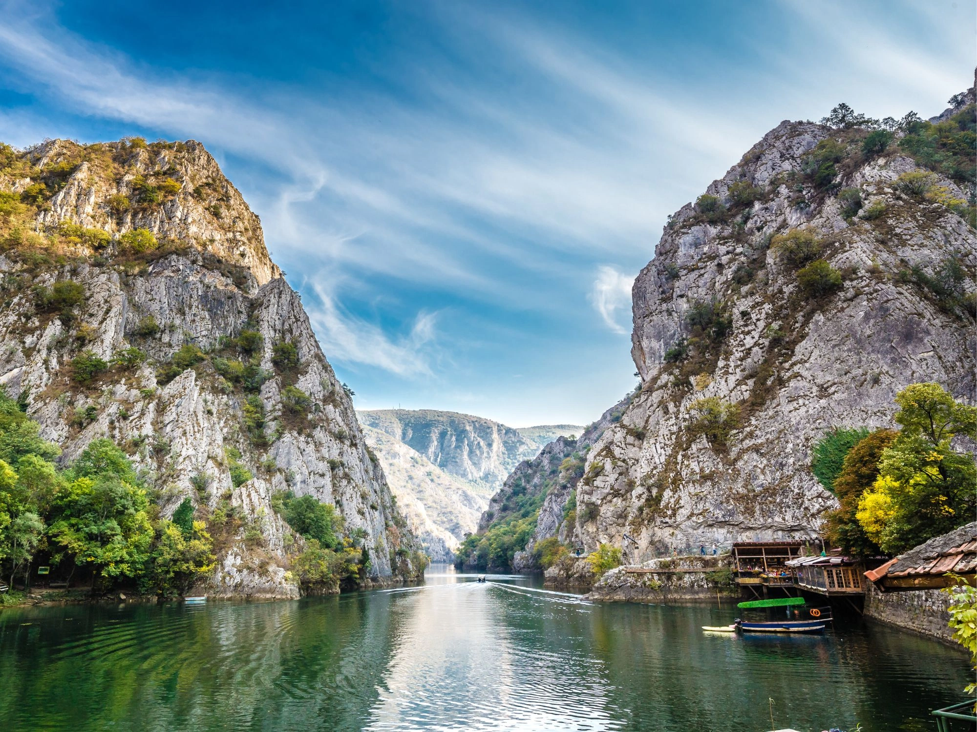 Scenic view of Matka Canyon in North Macedonia with steep cliffs, clear waters, and nature trails for explorers.