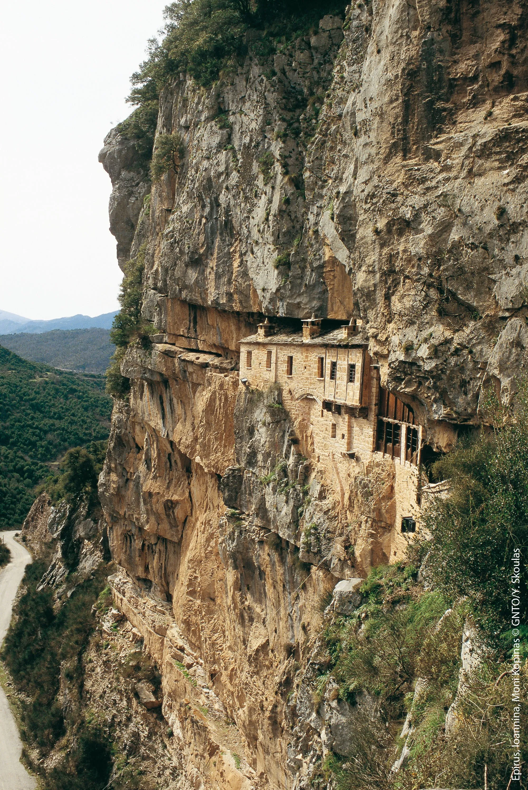 Kipina Monastery built into a dramatic rock cliff, showcasing cultural heritage in Tzoumerka, Epirus.