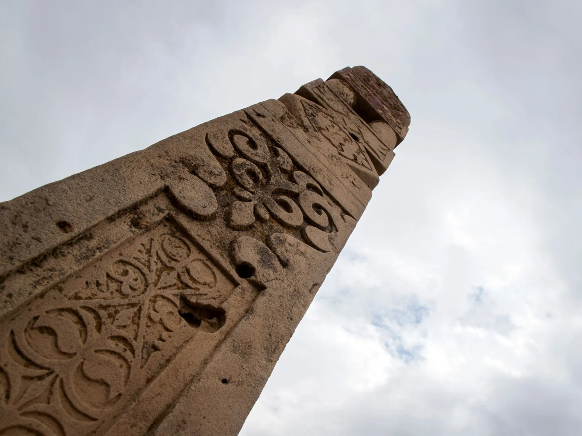 Intricately carved ancient stone pillar stands tall in Mangystau, Kazakhstan, reflecting rich cultural heritage.
