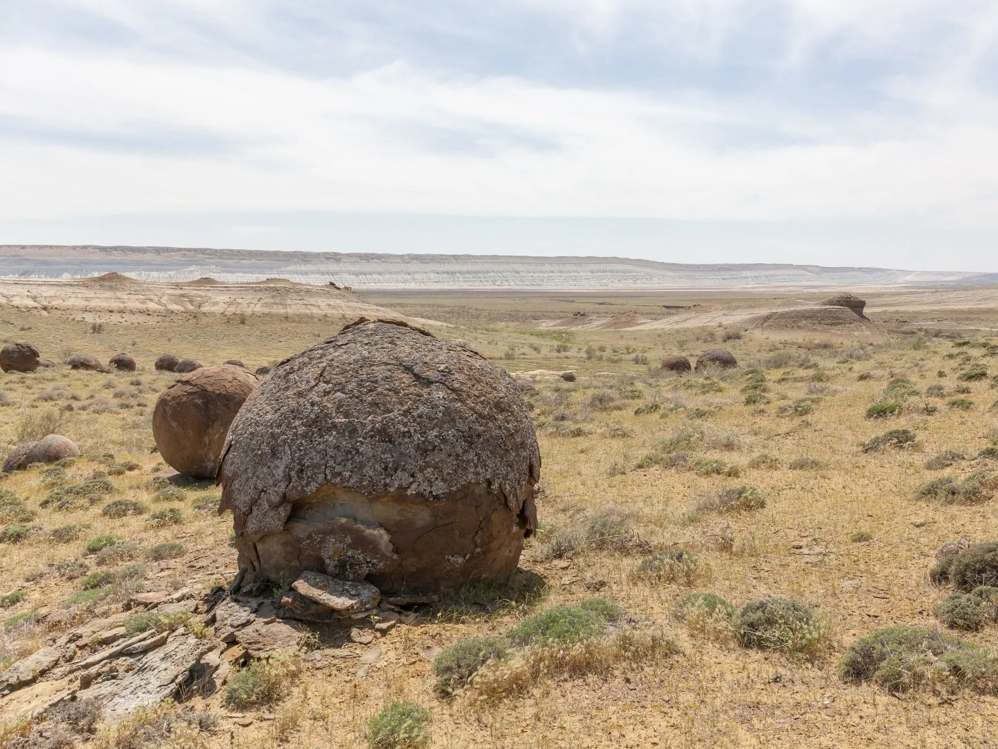 Ancient round rock formations dot the arid plains of Mangystau, Kazakhstan, remnants of the prehistoric Tethys Sea.